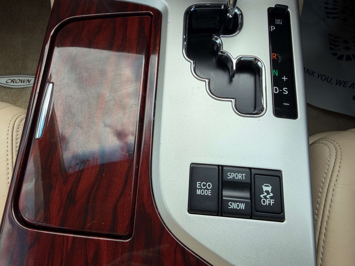 Interior console of a 2010 Toyota Crown V6 3.0L showing gear shift, drive mode buttons, and luxury details.