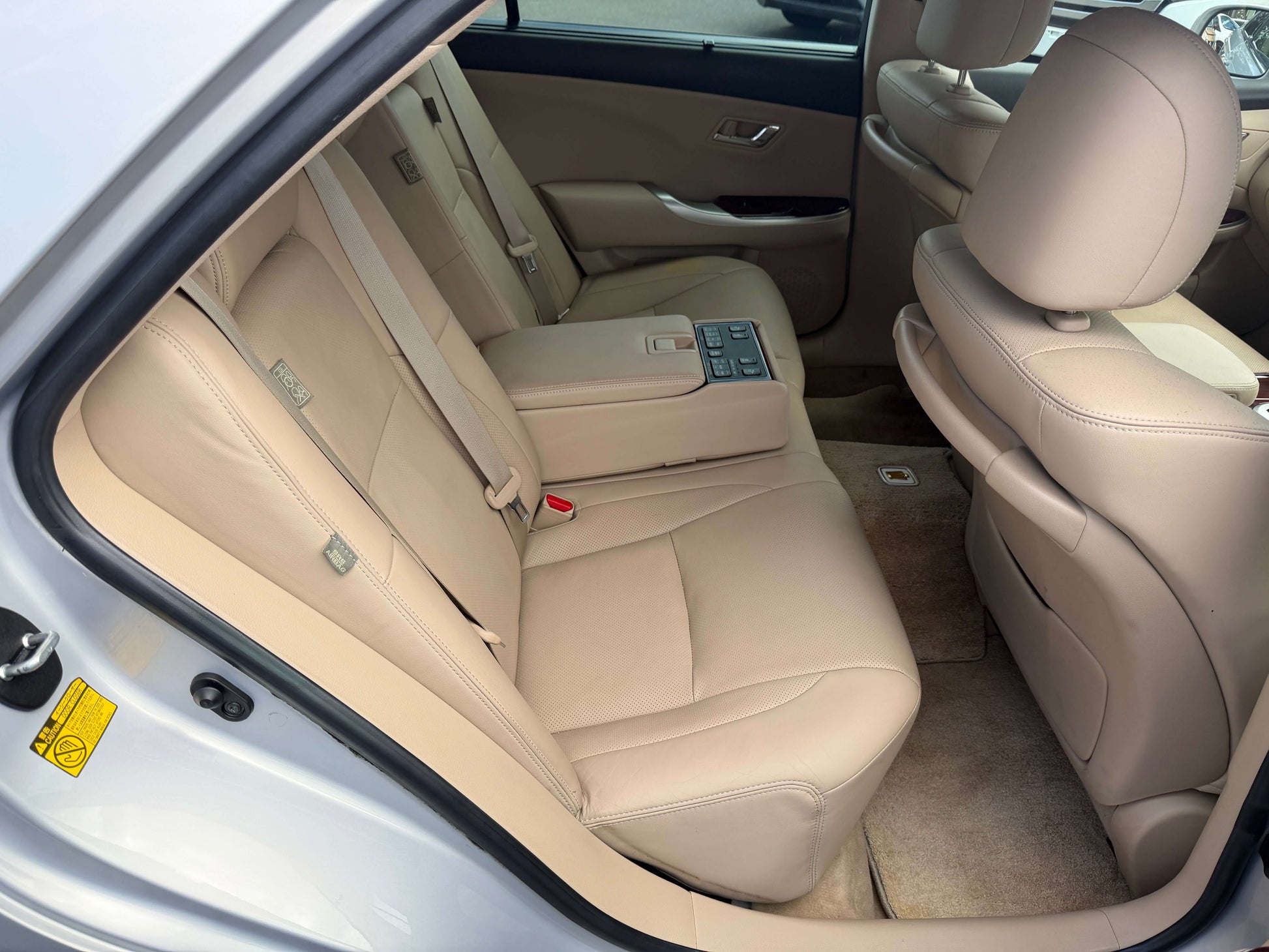 Interior view of the rear leather seats in the 2010 Toyota Crown V6 3.0L Royal Saloon G Edition luxury sedan.