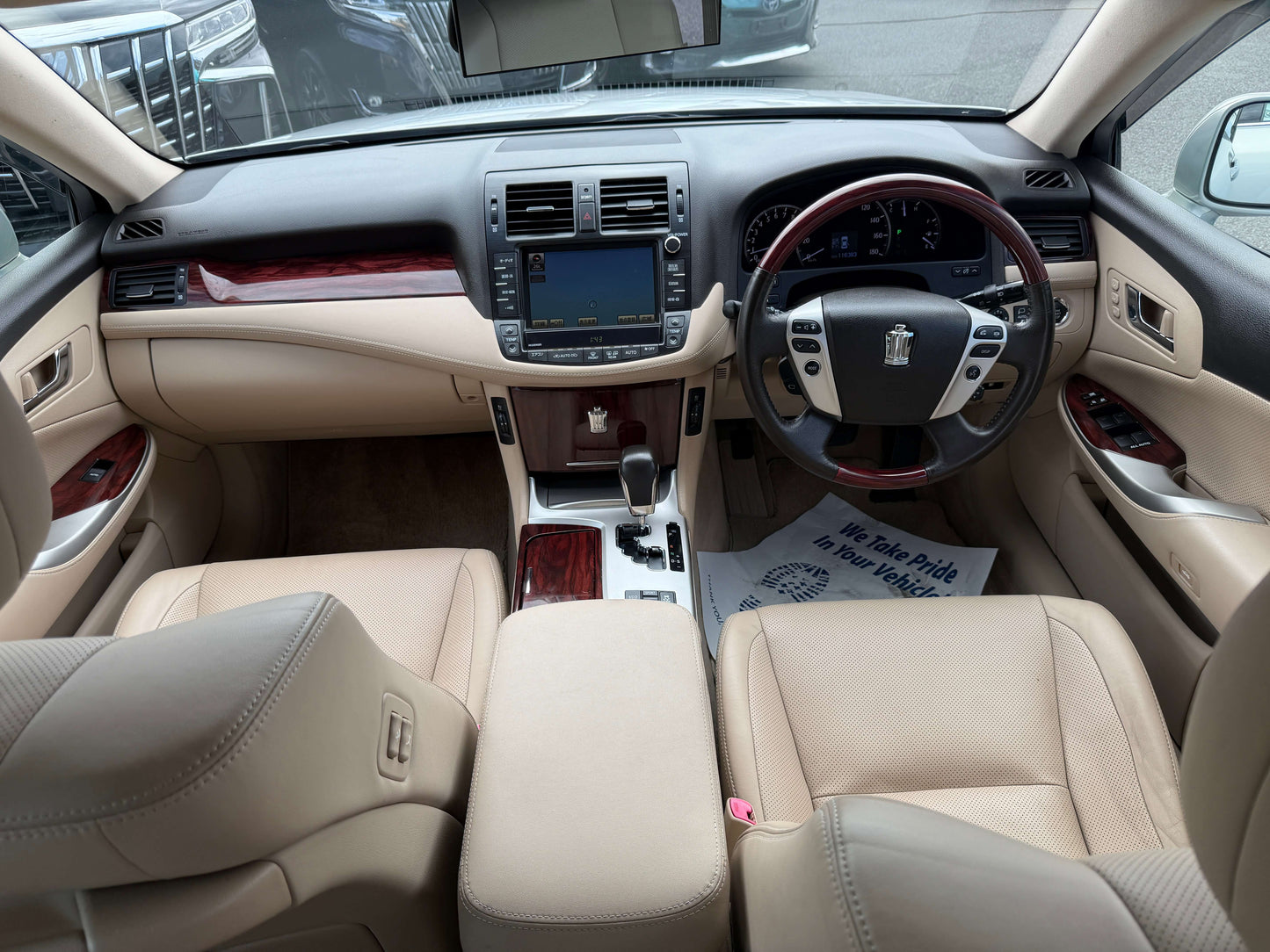 Interior view of 2010 Toyota Crown V6 3.0L Royal Saloon G Edition Luxury Sedan with beige leather seats.