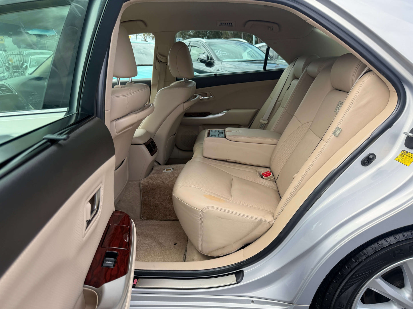 Interior view of the 2010 Toyota Crown V6 3.0L Royal Saloon G Edition Luxury Sedan featuring beige leather seats.