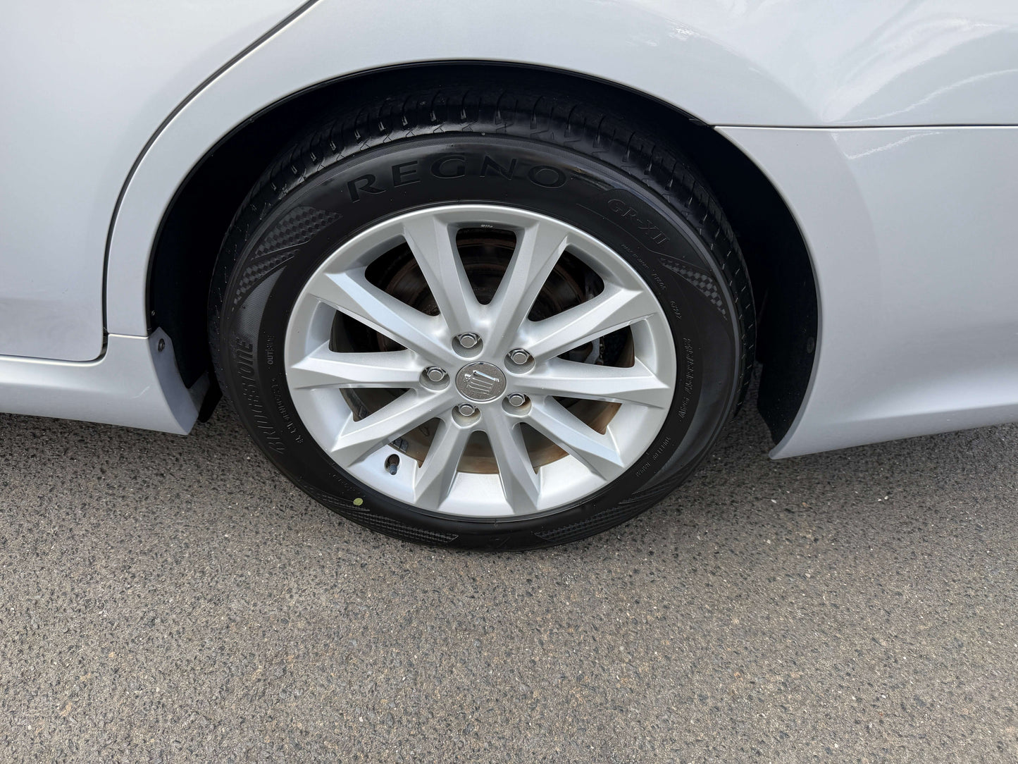 Close-up of the wheel and tire of a 2010 Toyota Crown V6 3.0L Royal Saloon G Edition Luxury Sedan.