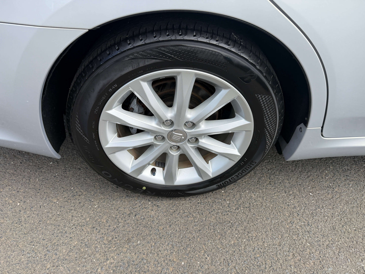 Close-up of 2010 Toyota Crown V6 3.0L luxury sedan tire and wheel design.