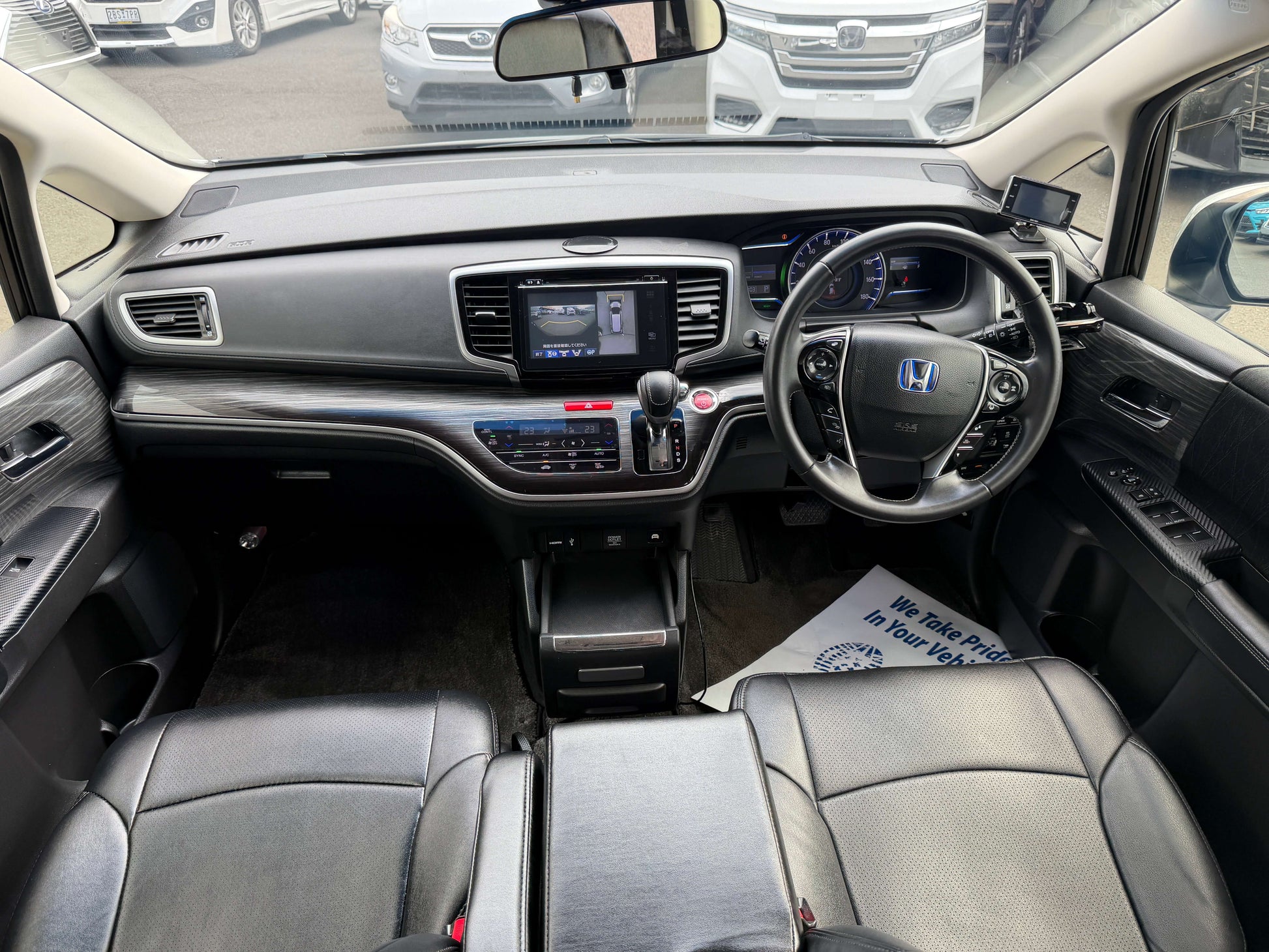 Interior view of the 2016 Honda Odyssey 2.0 Hybrid showcasing the dashboard and seating arrangement.