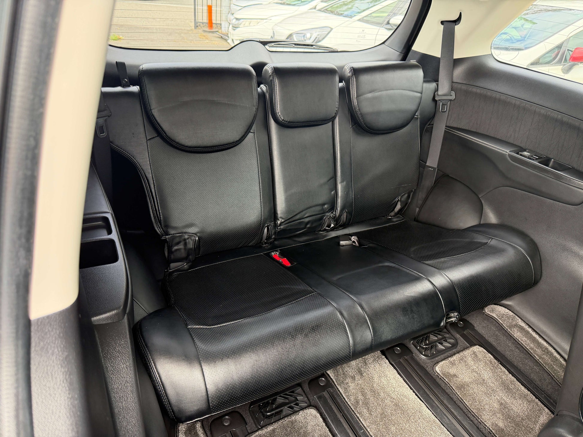 Interior view of the rear seats in the 2016 Honda Odyssey 2.0 Hybrid, showcasing spacious seating for passengers.