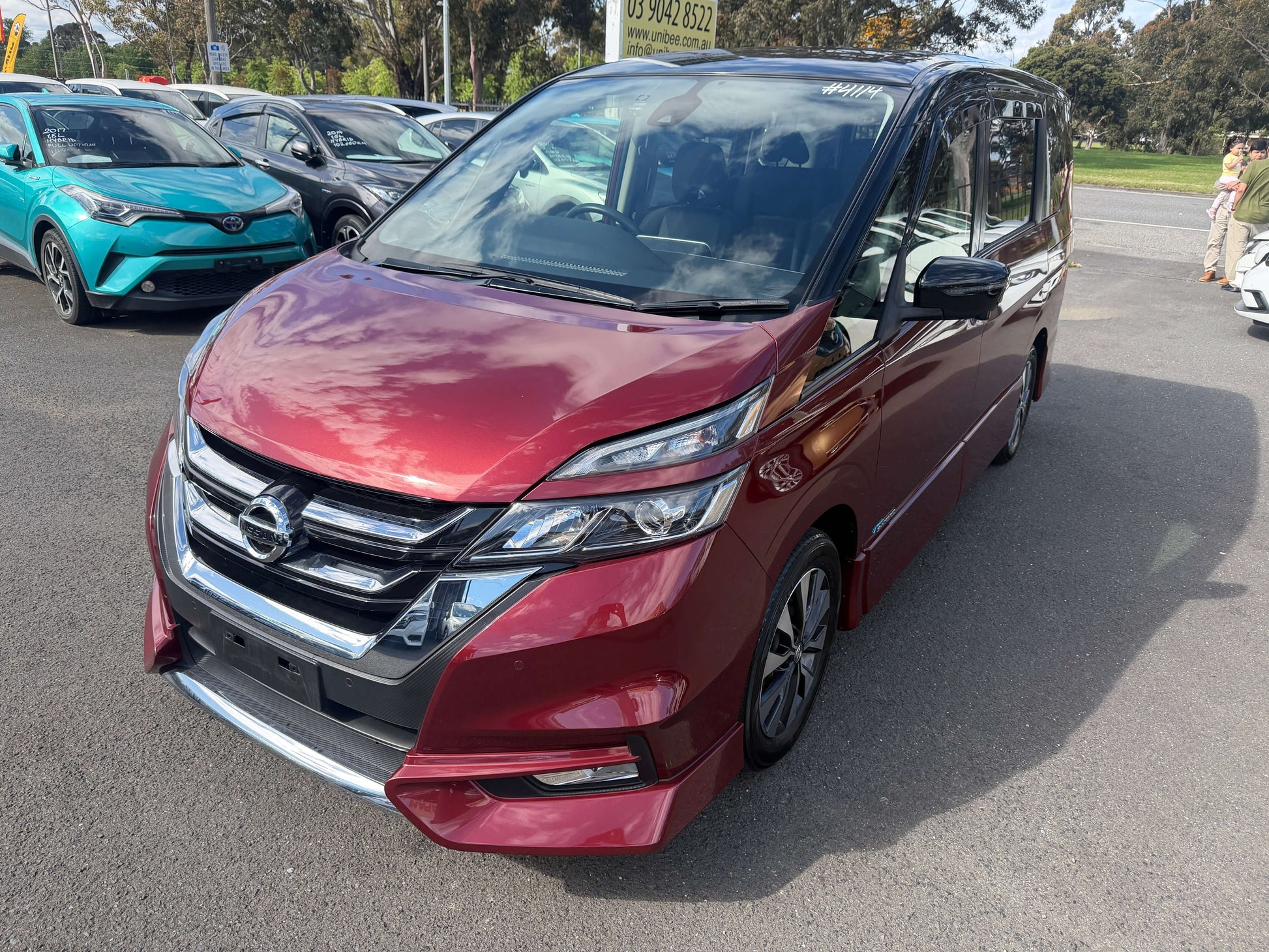 2016 Nissan Serena 2.0L S-Hybrid Highway Star Edition in red color, showcasing its stylish front design and 8-seat capacity.