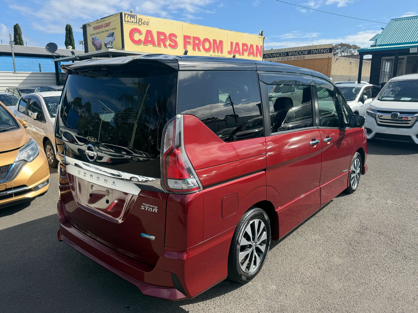 2016 Nissan Serena 2.0L S-Hybrid Highway Star Edition red minivan parked outside dealership