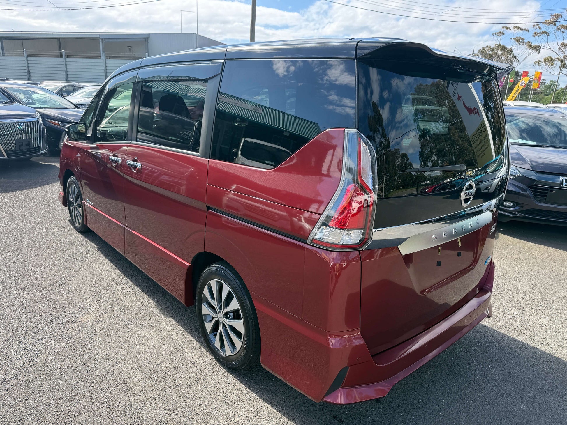 2016 Nissan Serena 2.0L S-Hybrid Highway Star Edition rear view, 8 seats, maroon color, showcased in parking lot.