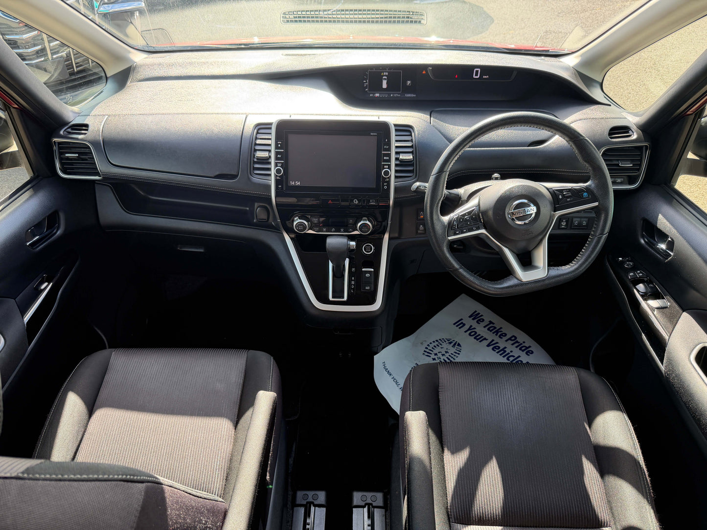 Interior view of 2016 Nissan Serena 2.0L S-Hybrid Highway Star with spacious seating and modern dashboard.