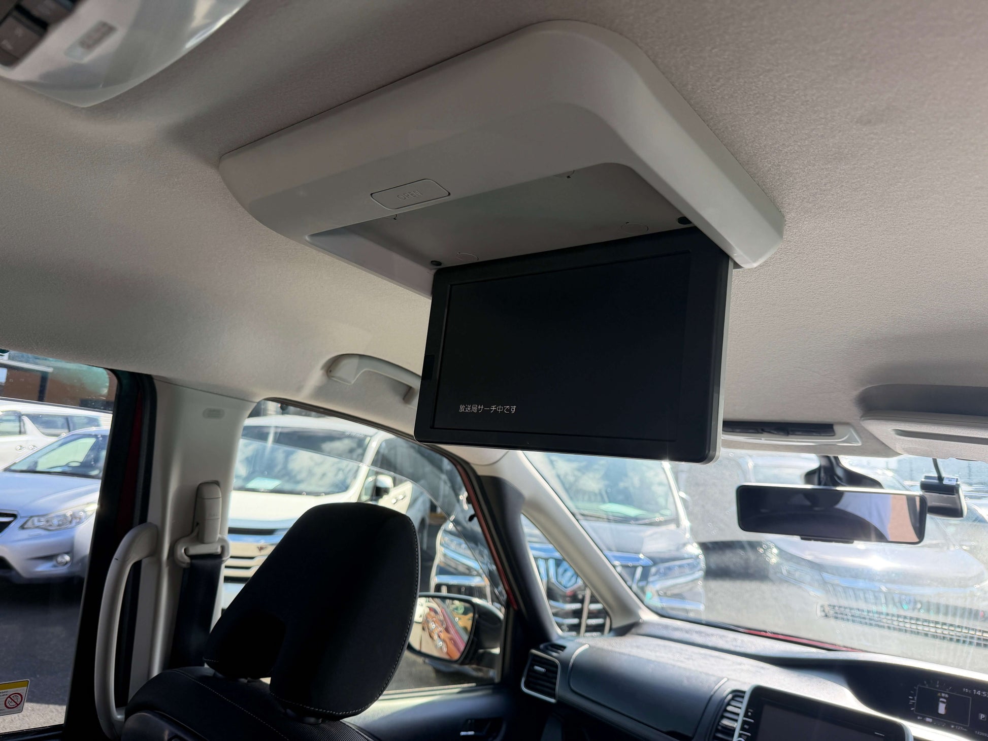 Interior view of a 2016 Nissan Serena 2.0L S-Hybrid showing the drop-down screen for entertainment.
