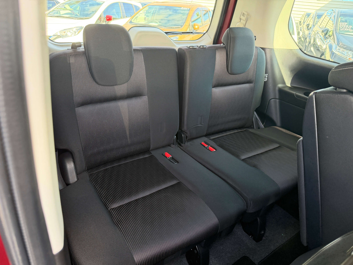 2016 Nissan Serena 2.0L S-Hybrid interior showing three back seats with black upholstery in a spacious layout.