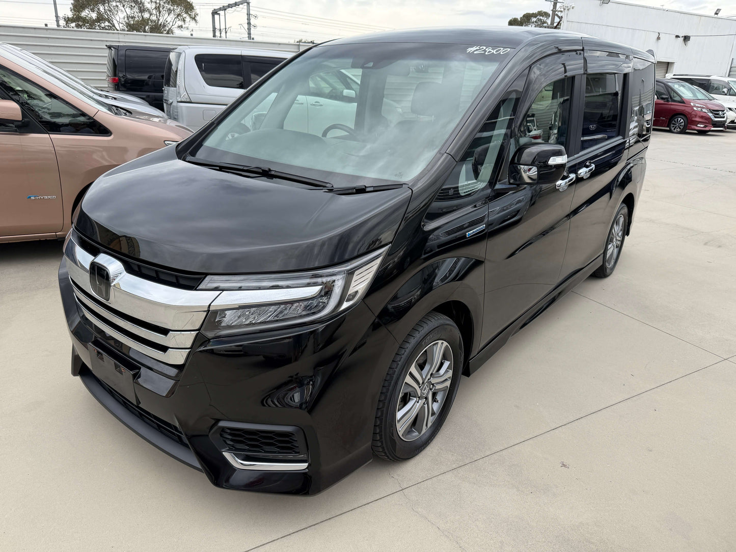 2018 Honda Stepwgn 2.0 Spada Hybrid G Honda Sensing black MPV parked in a lot with clear visibility.