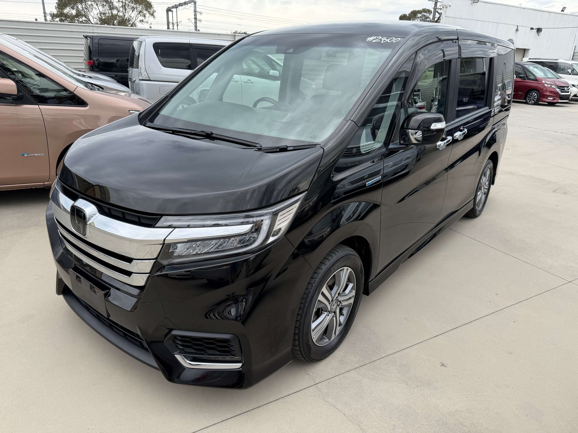 2018 Honda Stepwgn 2.0 Spada Hybrid G Honda Sensing black MPV parked in a lot with clear visibility.