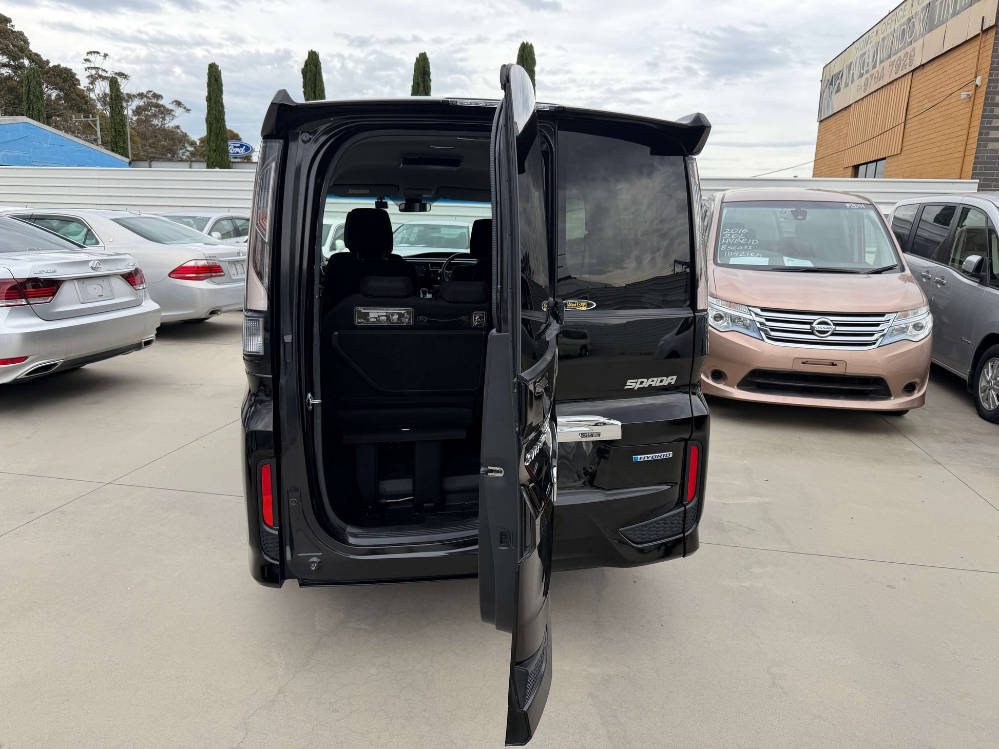2018 Honda Stepwgn 2.0 Spada Hybrid G Honda Sensing showing the spacious interior with an open door in a vehicle lot.