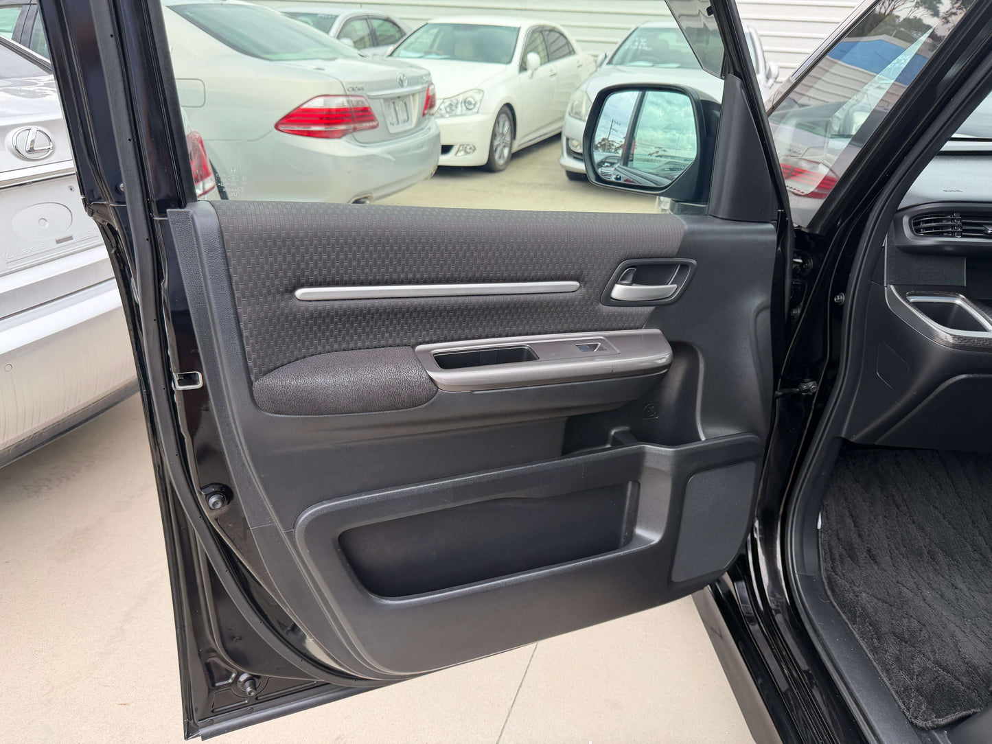 Interior view of the 2018 Honda Stepwgn 2.0 Spada Hybrid G door panel showing controls and materials.