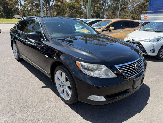 2007 Lexus LS600h AWD V8 5.0L Hybrid luxury sedan parked outdoors, showcasing sleek black exterior and chrome details.