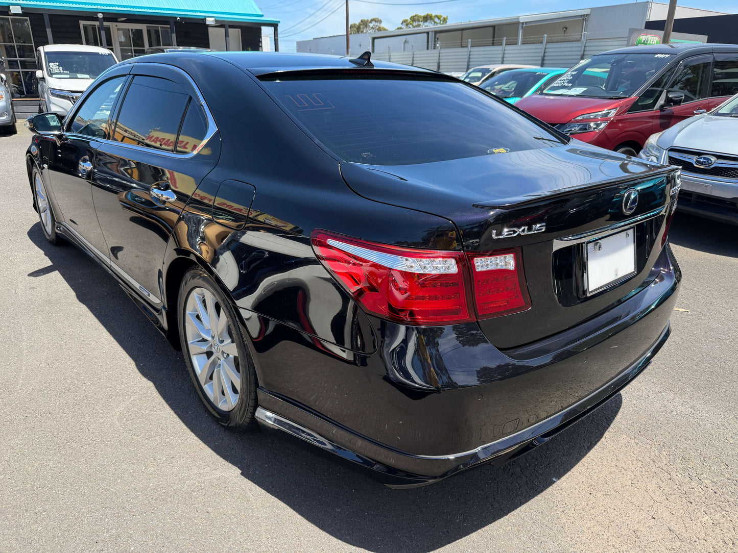 2007 Lexus LS600hL AWD V8 5.0L Hybrid Luxury Sedan rear view in black color with sleek design and shiny wheels.