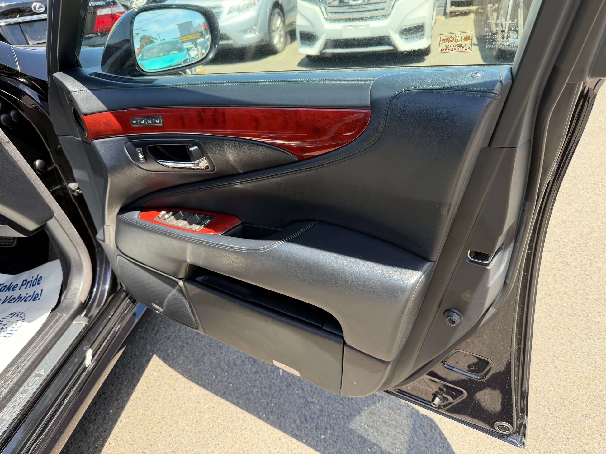 Interior door panel of a 2007 Lexus LS600hL AWD V8 5.0L Hybrid showing luxury finishes and design.