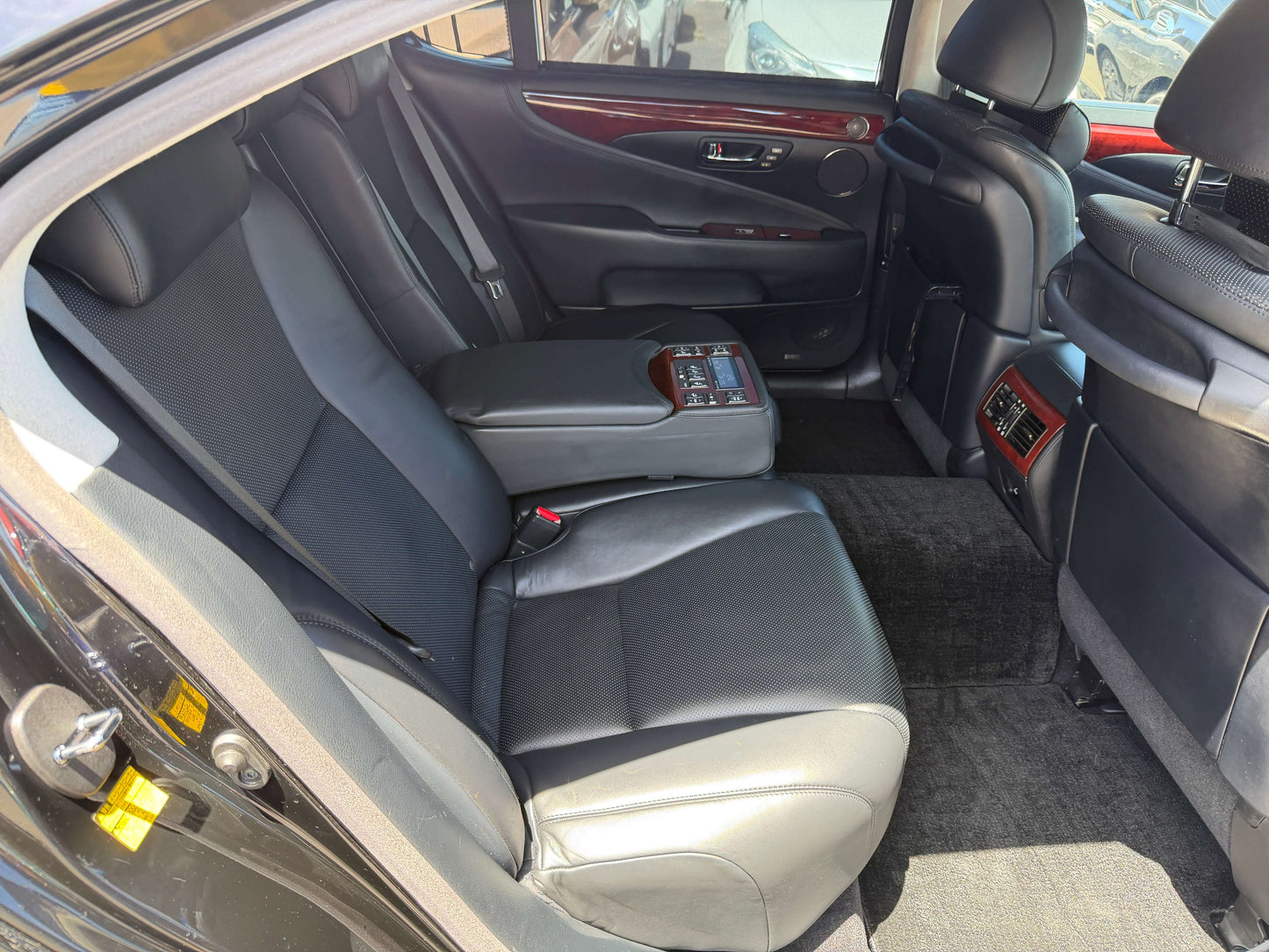 Interior view of a 2007 Lexus LS600hL AWD V8 5.0L Hybrid luxury sedan's back seats showcasing premium leather.