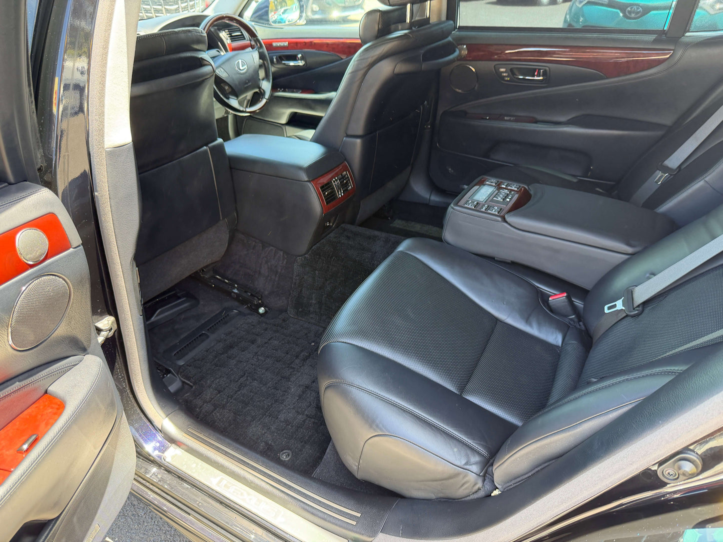 Interior view of 2007 Lexus LS600hL AWD V8 5.0L Hybrid Luxury Sedan showcasing spacious black leather seats.