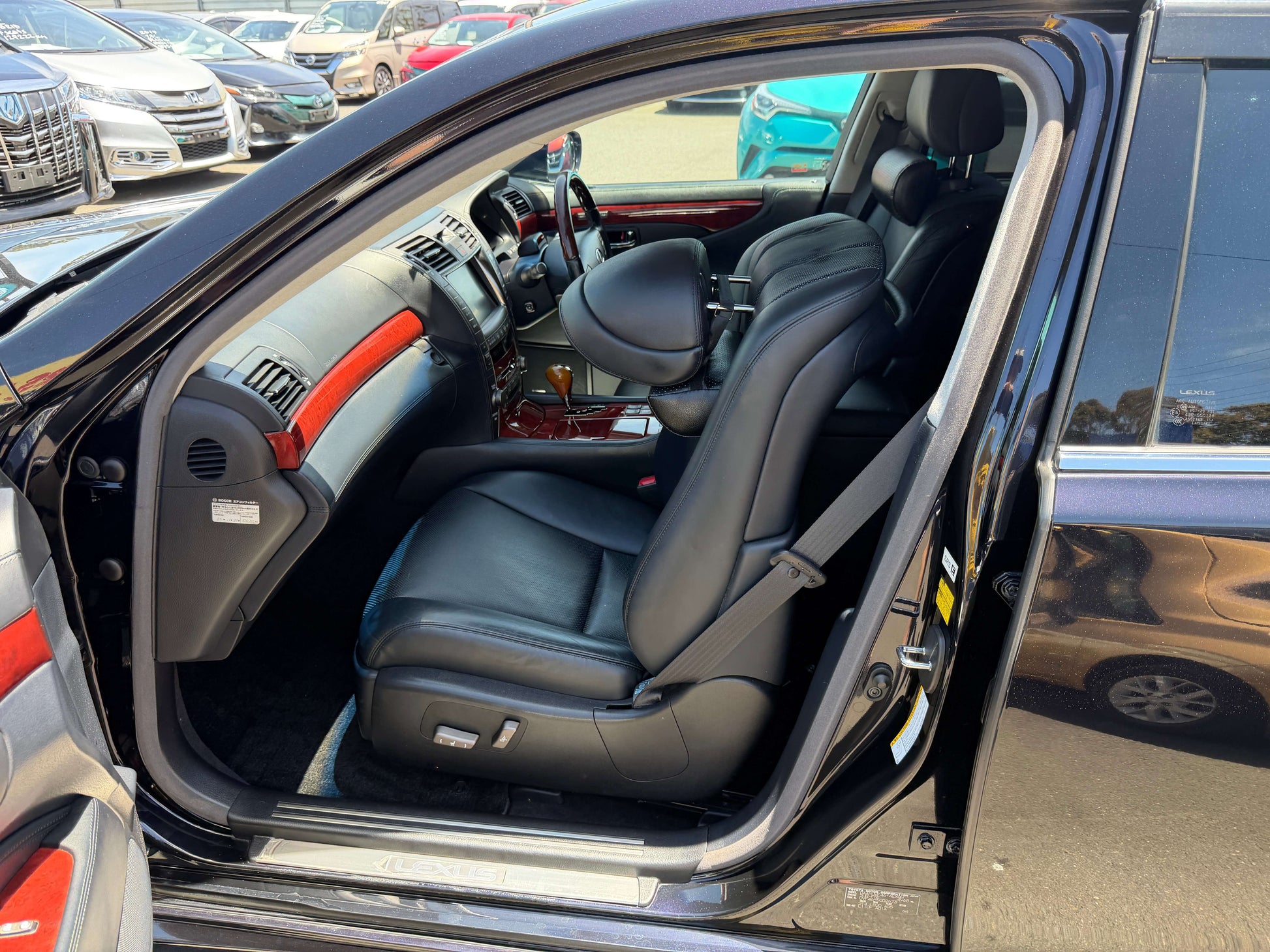 Interior view of 2007 Lexus LS600hL AWD V8 5.0L Hybrid Luxury Sedan showing black leather front seats.