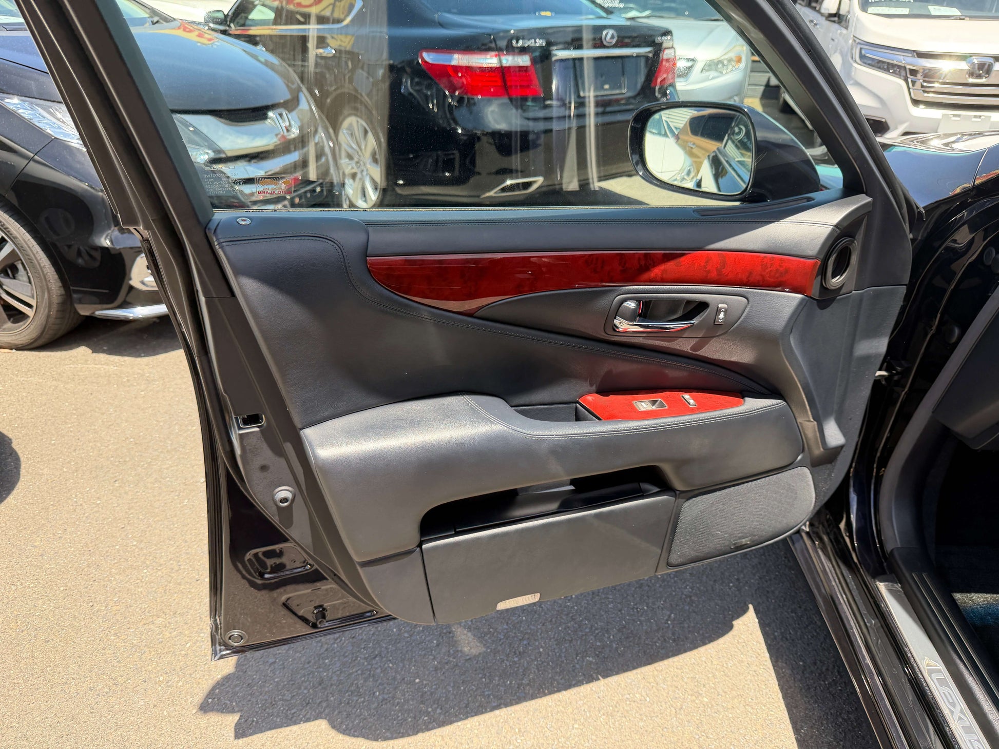 Interior view of the 2007 Lexus LS600hL AWD V8 5.0L Hybrid luxury sedan door with wood trim.
