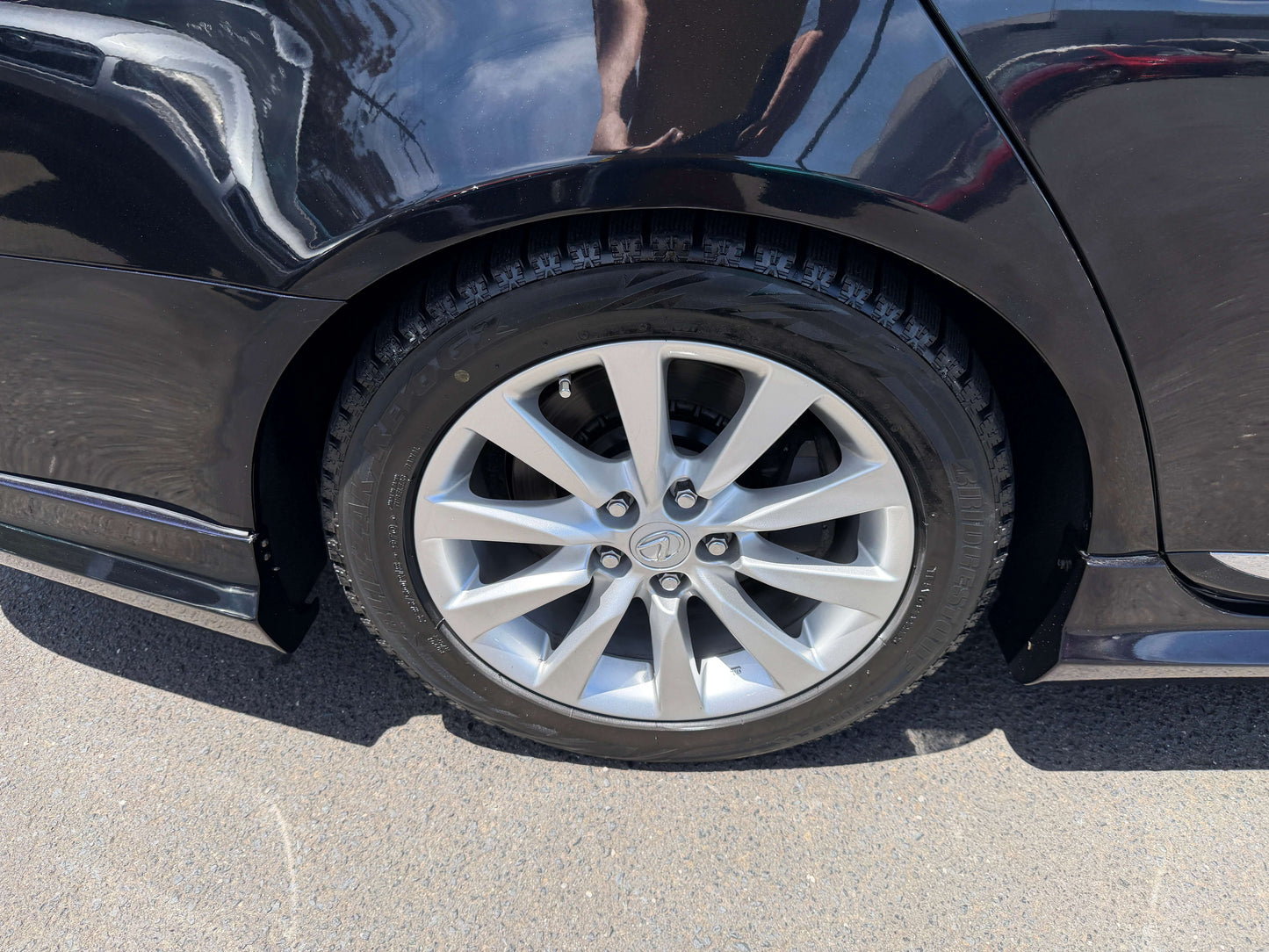 Close-up view of a silver alloy wheel with tire on a 2007 Lexus LS600hL AWD V8 5.0L Hybrid luxury sedan.