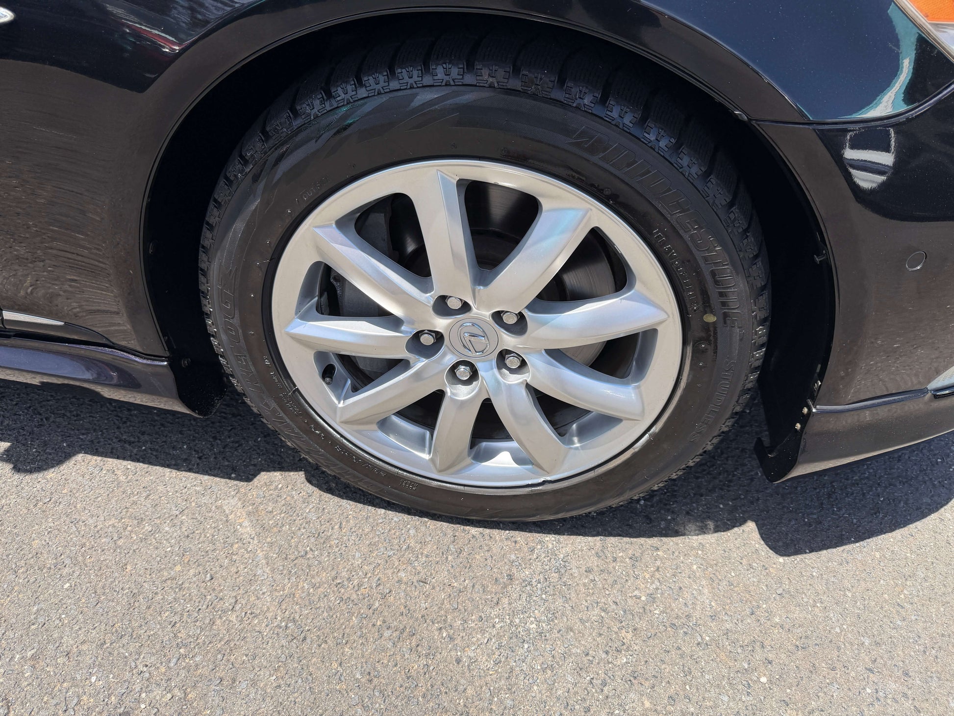 Close-up of the alloy wheel of a 2007 Lexus LS600hL AWD V8 5.0L Hybrid Luxury Sedan showcasing its design.