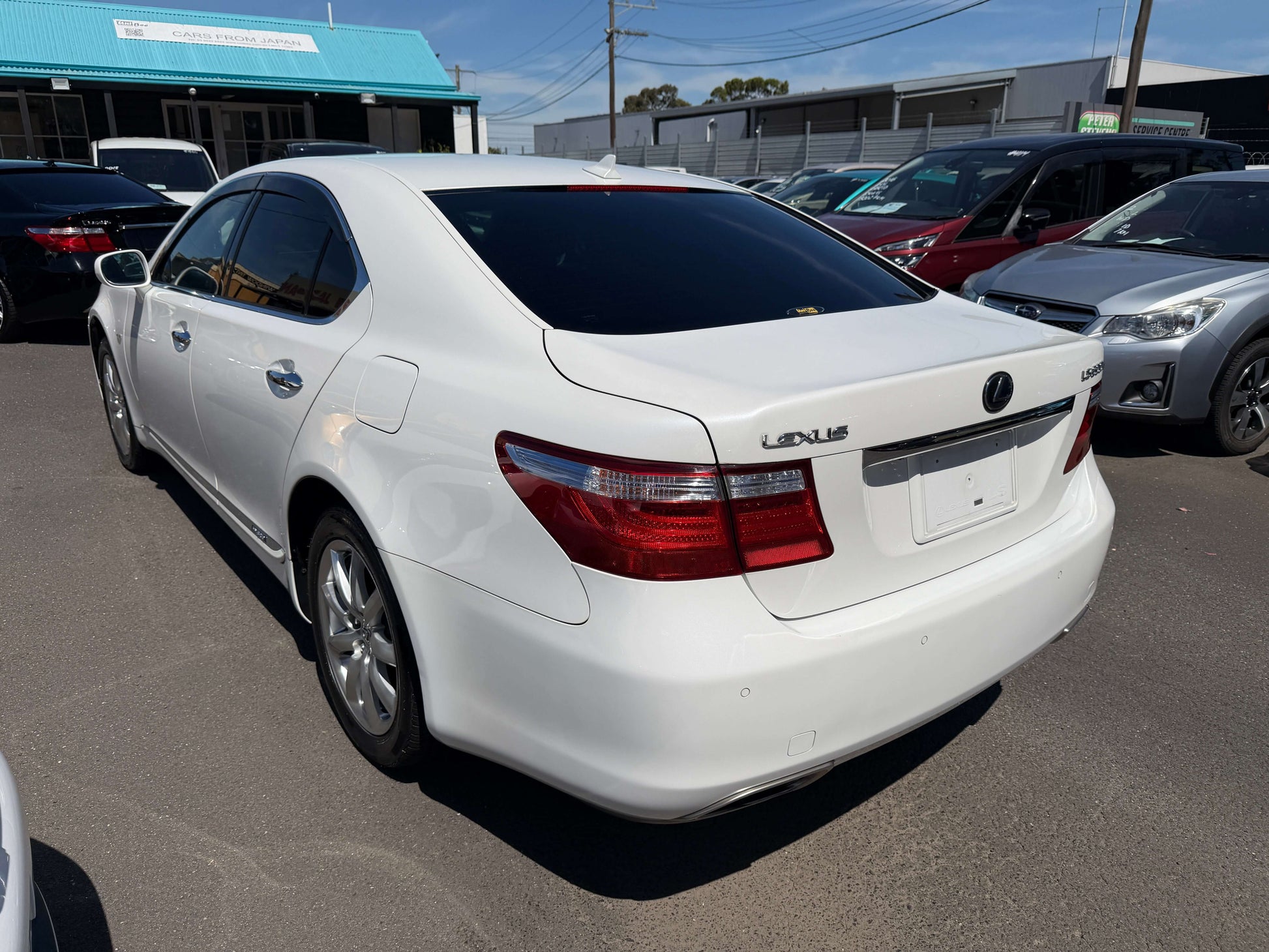 2007 Lexus LS600h AWD V8 5.0L Hybrid luxury sedan rear view with a clean white exterior and tinted windows.