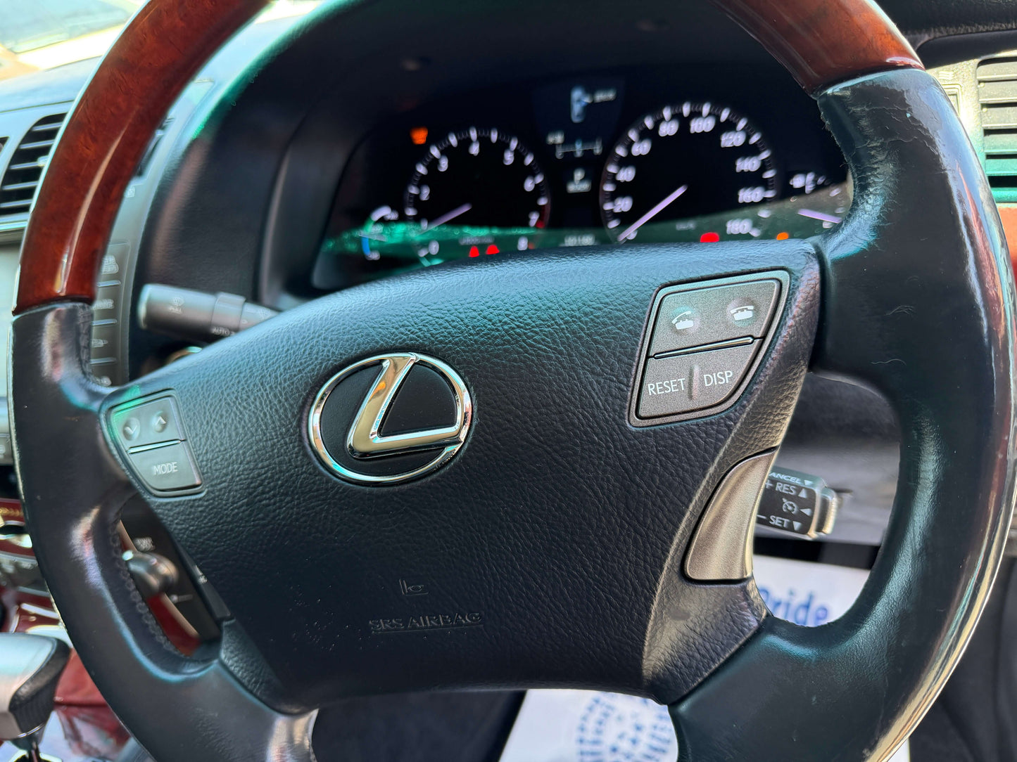 2007 Lexus LS600h AWD V8 5.0L Hybrid luxury sedan steering wheel with controls and dashboard in background