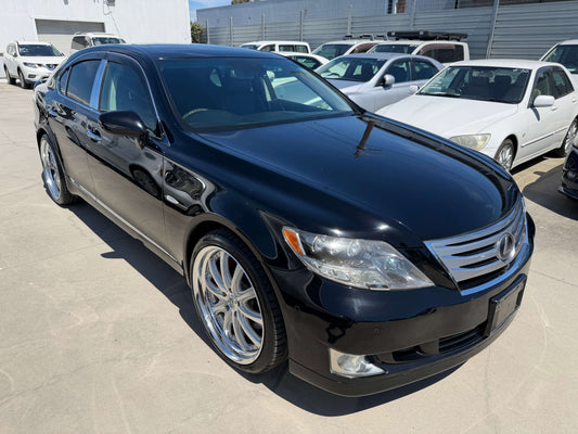 2007 Lexus LS600h AWD V8 5.0L Hybrid luxury sedan in black with alloy wheels, parked in a car lot.