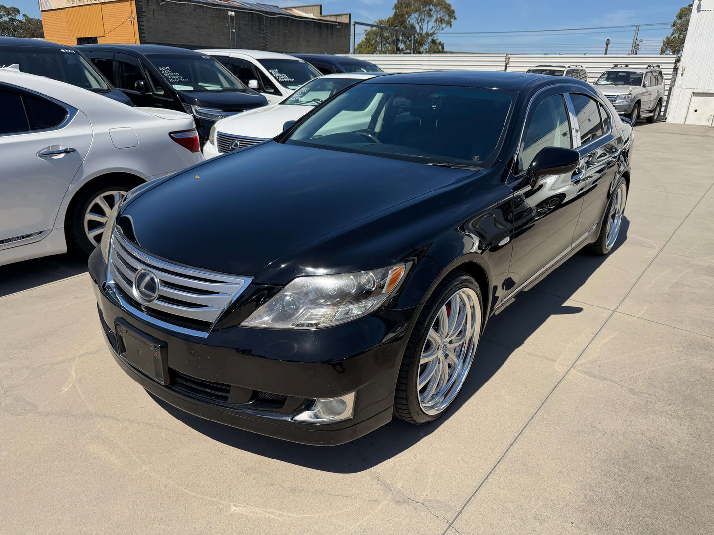 2007 Lexus LS600h AWD V8 5.0L Hybrid luxury sedan parked, showcasing sleek black exterior and stylish wheels.