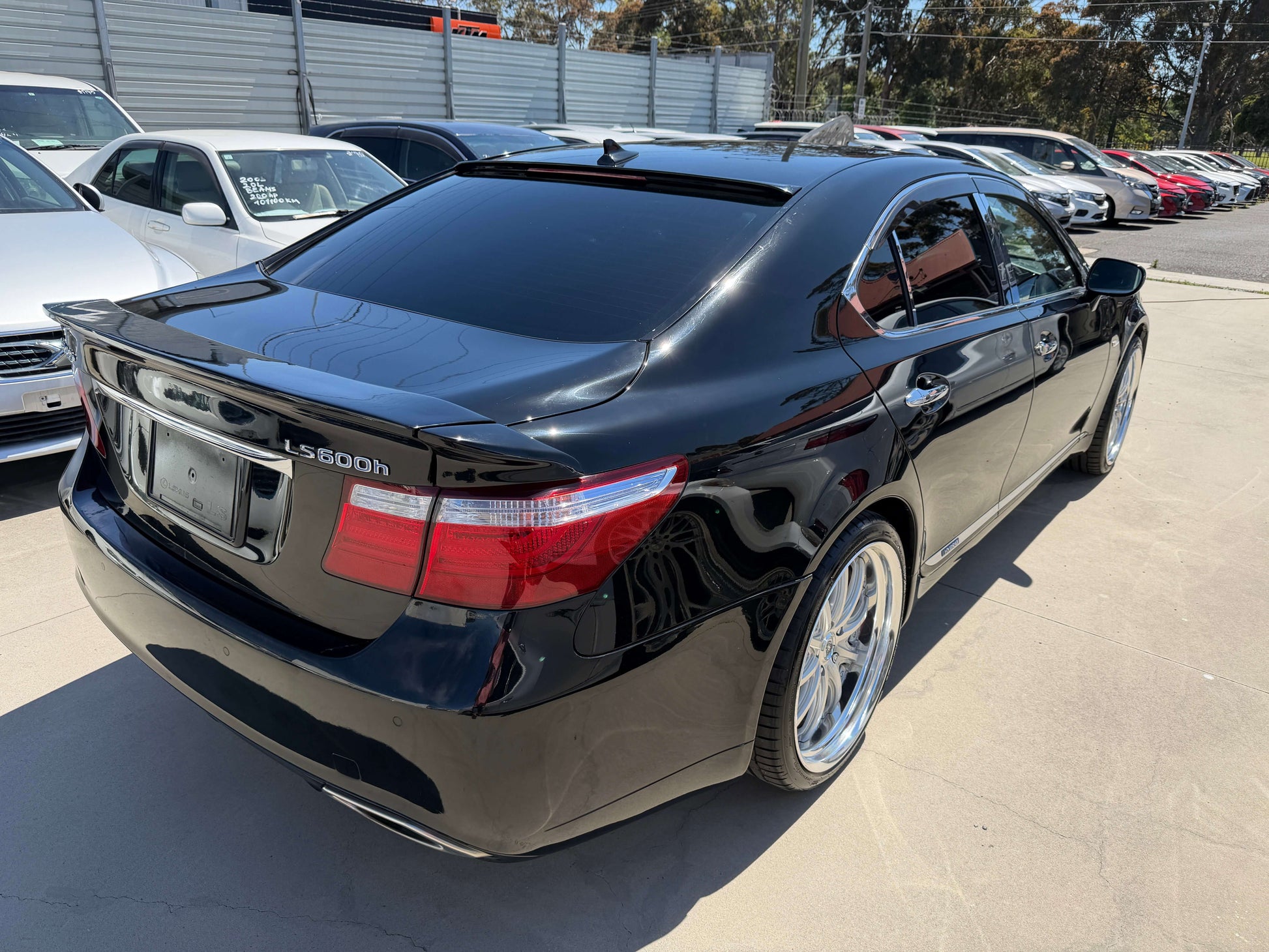 2007 Lexus LS600h AWD V8 5.0L Hybrid luxury sedan rear view with polished wheels and sleek black exterior