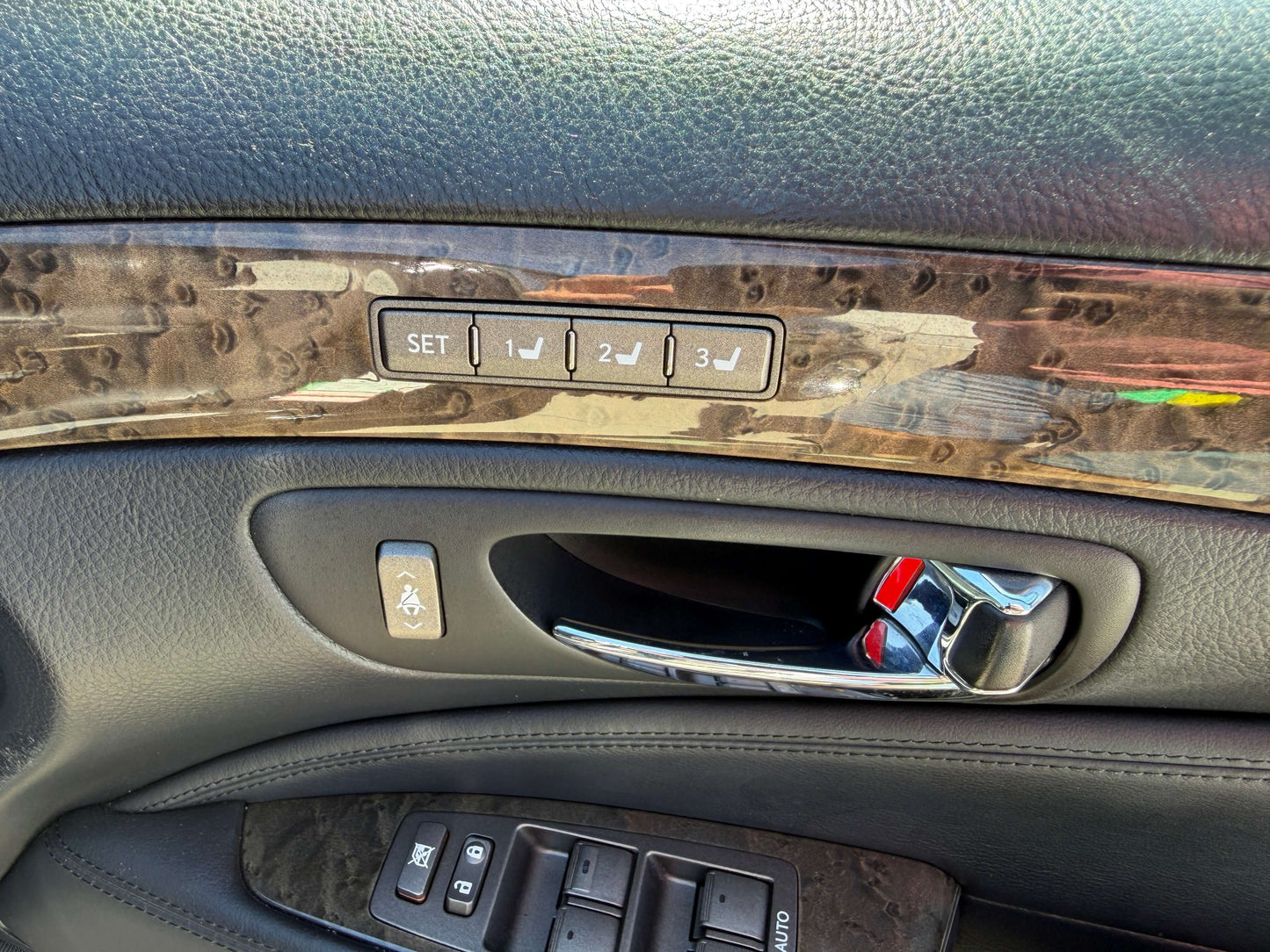 2007 Lexus LS600h AWD V8 5.0L Hybrid luxury sedan door control panel with seat adjustment buttons.