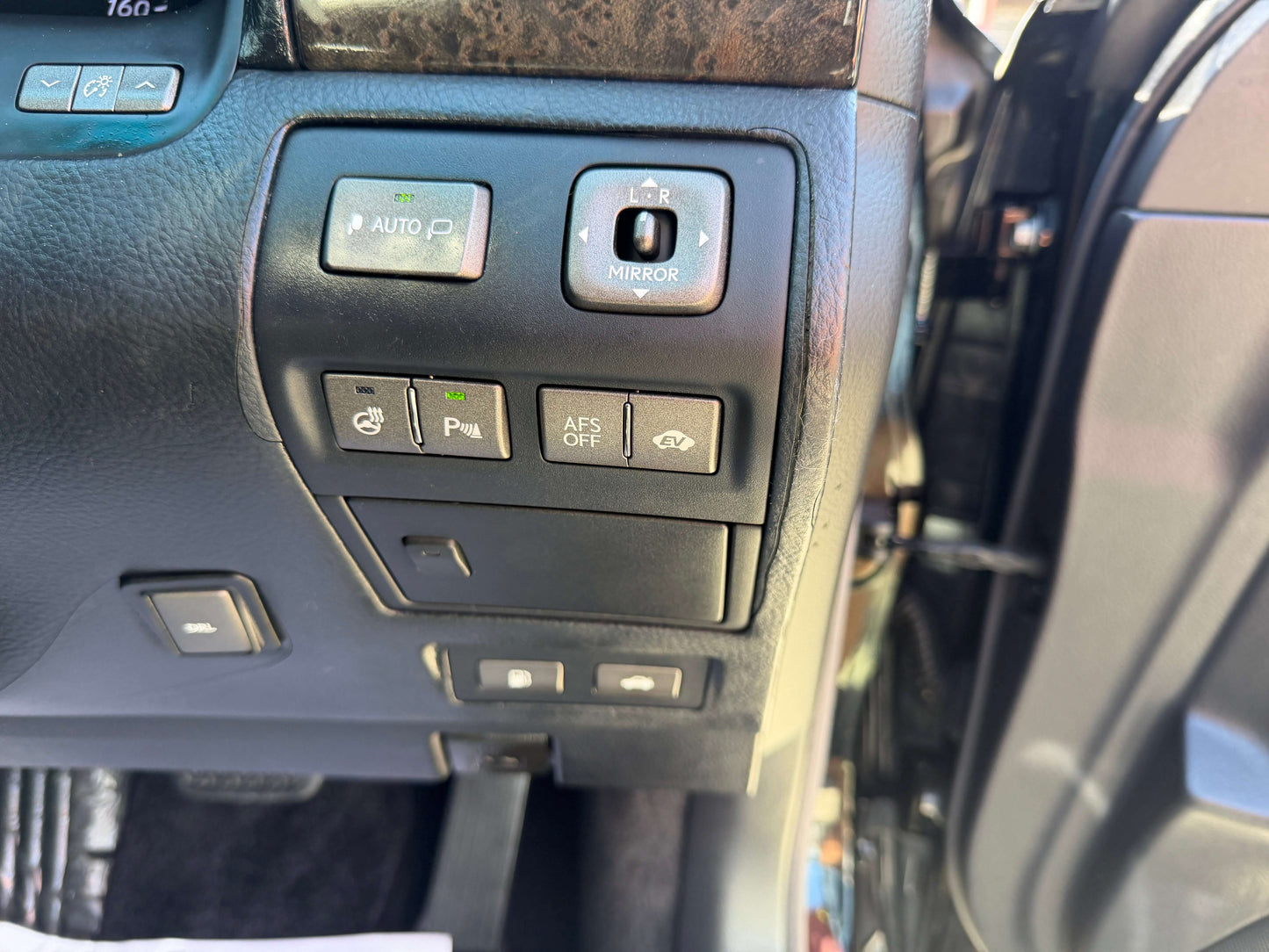 Interior controls of a 2007 Lexus LS600h AWD V8 5.0L Hybrid luxury sedan showcasing various functionality buttons.