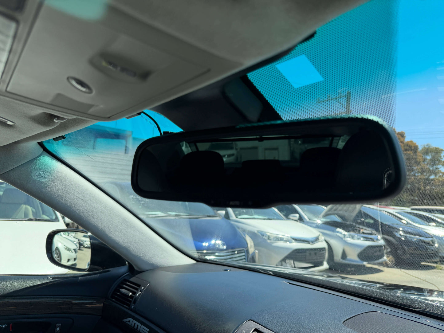 Interior view of 2007 Lexus LS600h AWD V8 5.0L Hybrid showcasing rearview mirror and dashboard, capturing luxurious sedan features.