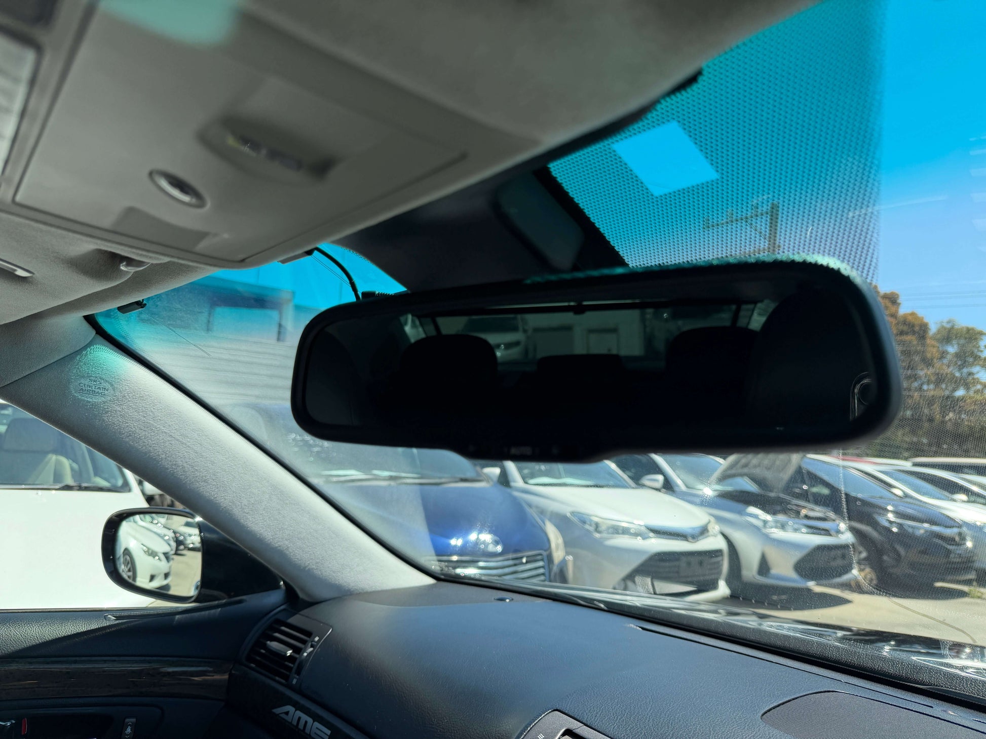 Interior view of 2007 Lexus LS600h AWD V8 5.0L Hybrid showcasing rearview mirror and dashboard, capturing luxurious sedan features.