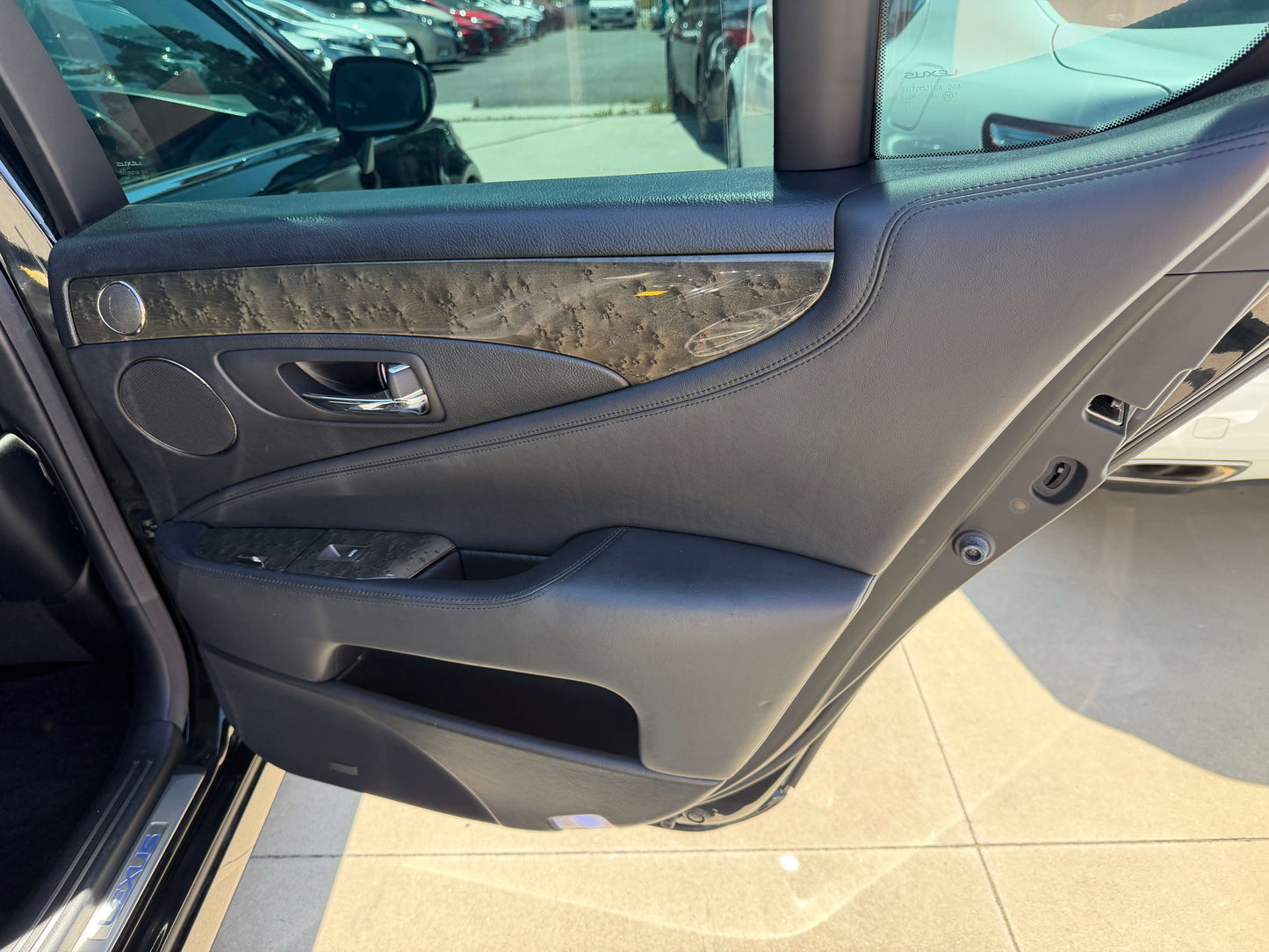 Luxury interior detailing of the 2007 Lexus LS600h AWD V8 5.0L Hybrid door panel.