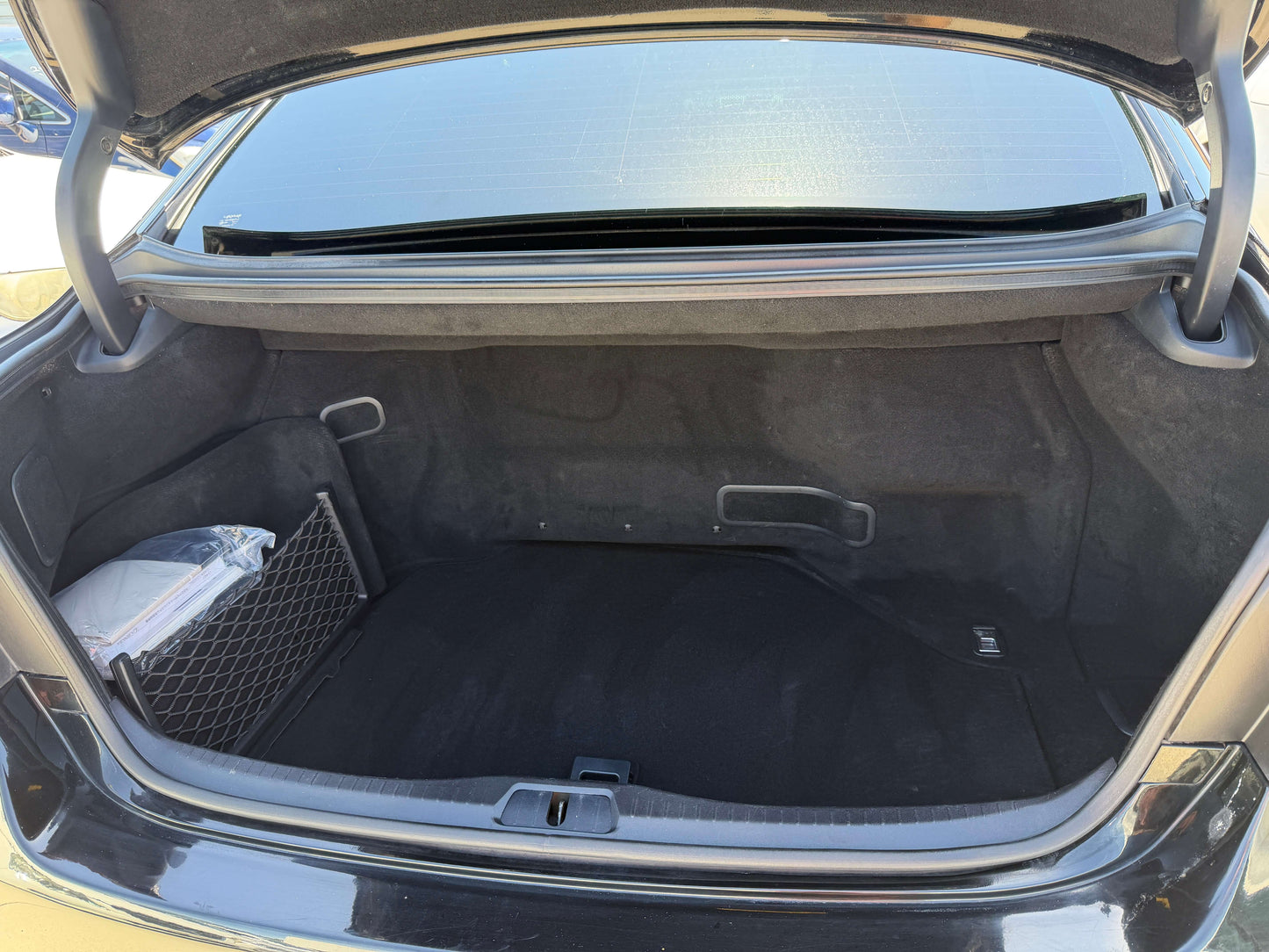 Trunk interior of a 2007 Lexus LS600h AWD V8 5.0L Hybrid, showcasing spacious cargo area and storage features.