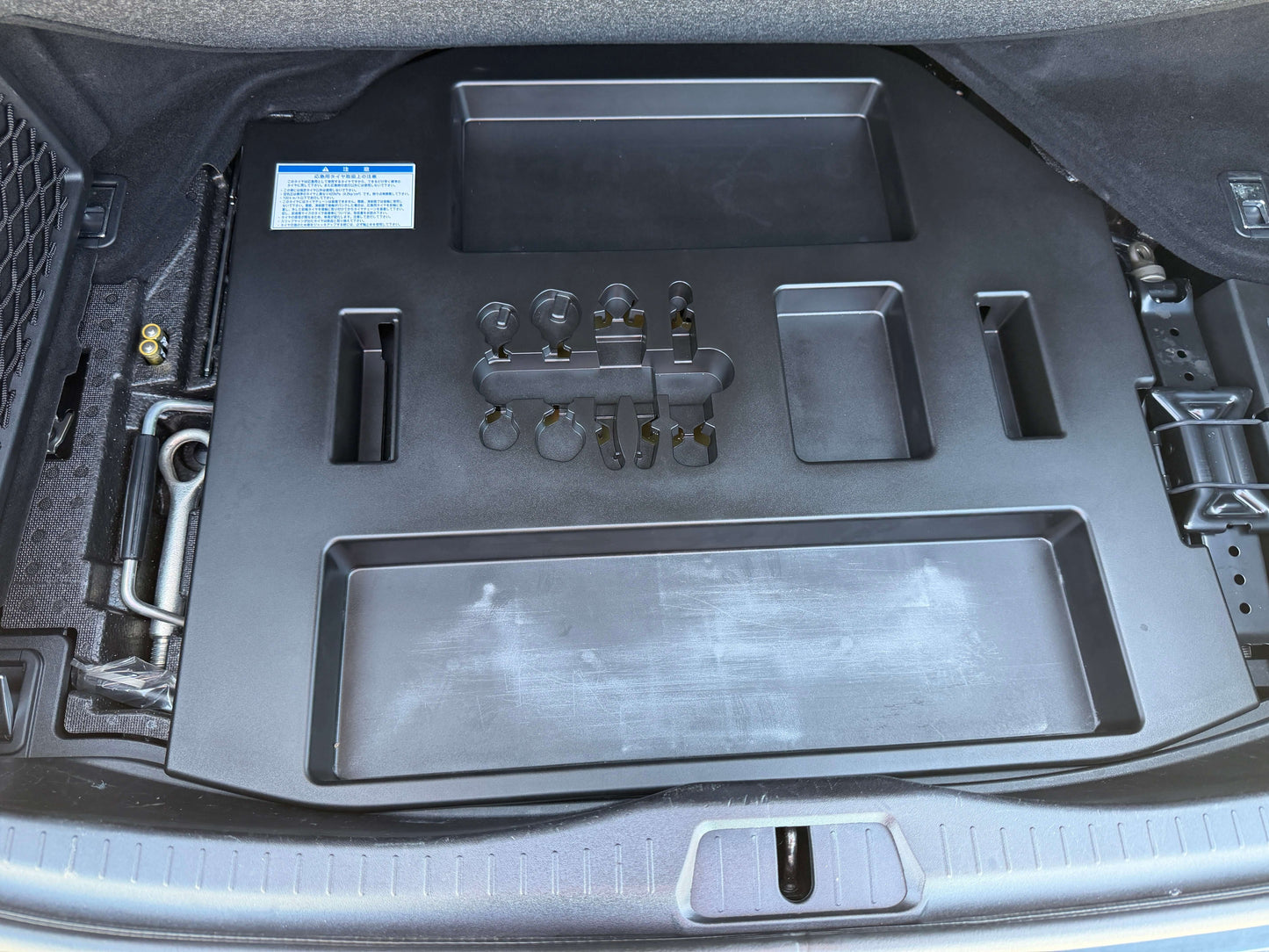 Storage compartment layout in the trunk of a 2007 Lexus LS600h AWD V8 5.0L Hybrid luxury sedan.