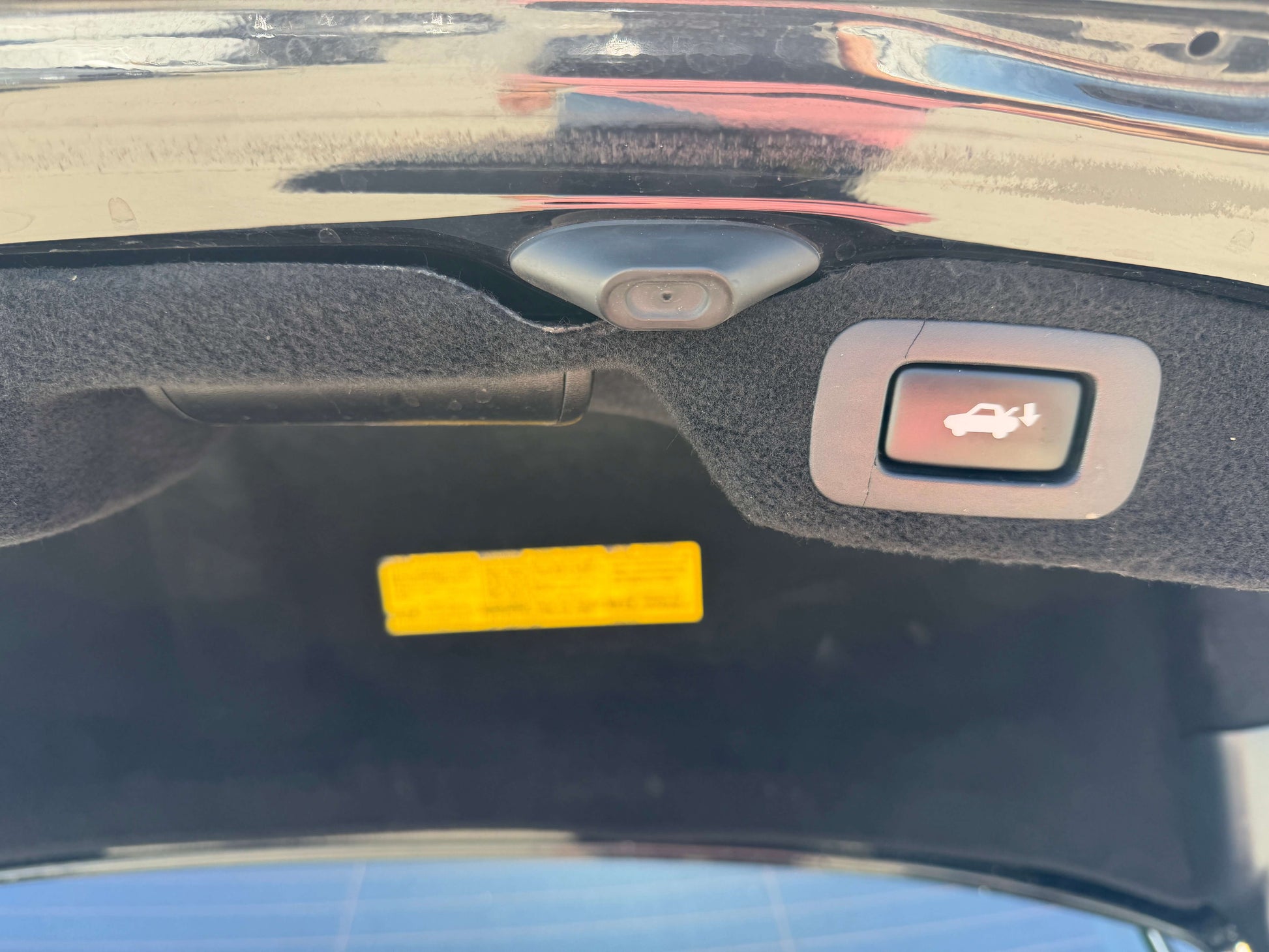 View of 2007 Lexus LS600h AWD V8 5.0L Hybrid trunk interior showing release button and camera.