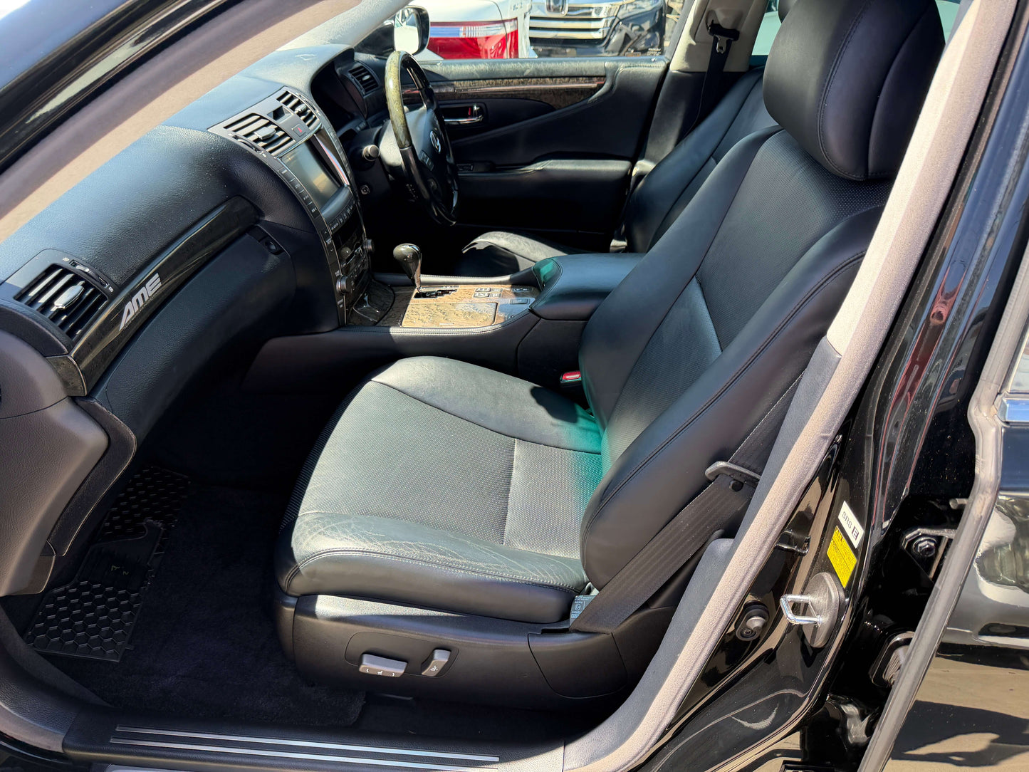 Interior view of the 2007 Lexus LS600h AWD V8 5.0L Hybrid Luxury Sedan showing black leather seats and dashboard.