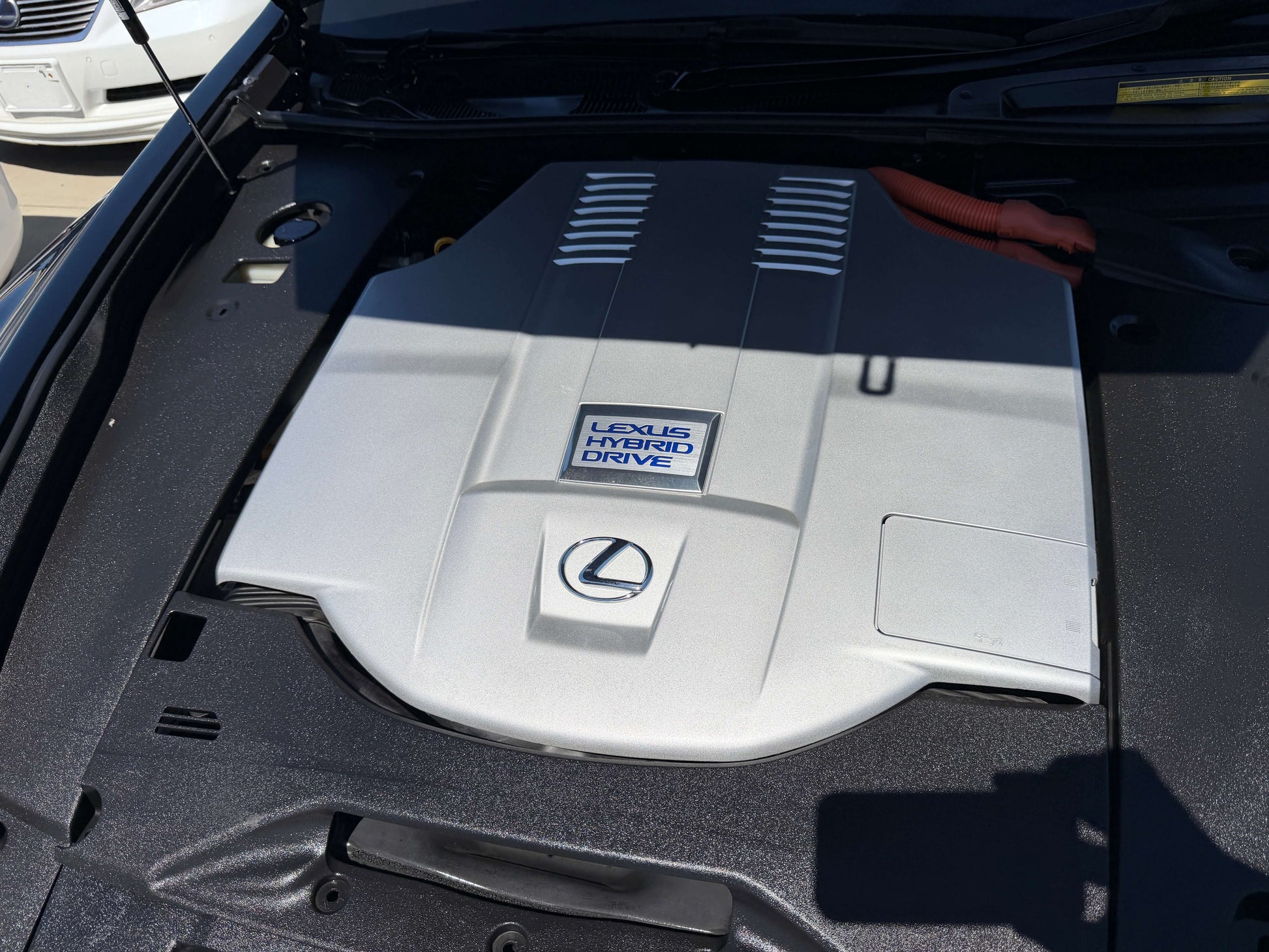 Image of the engine cover of a 2007 Lexus LS600h AWD V8 5.0L Hybrid showcasing the hybrid drive system.