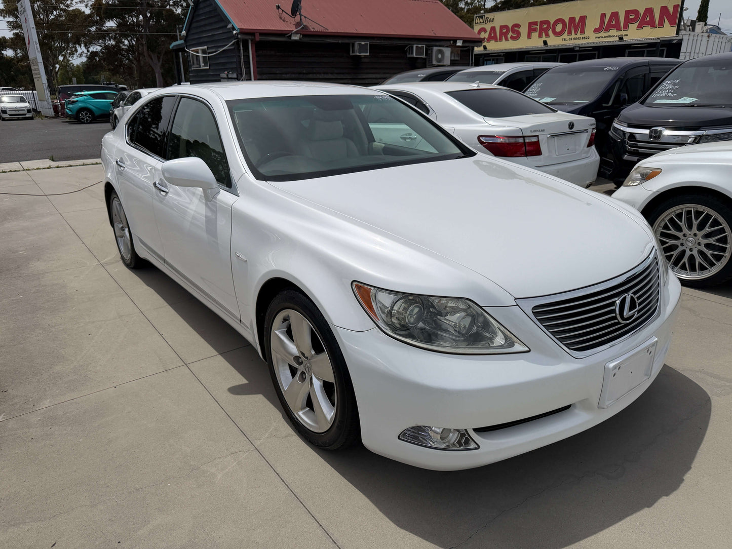 2007 Lexus LS460 V8 4.6L Version S I Package luxury sedan in white parked outside, showing sleek design and premium features.