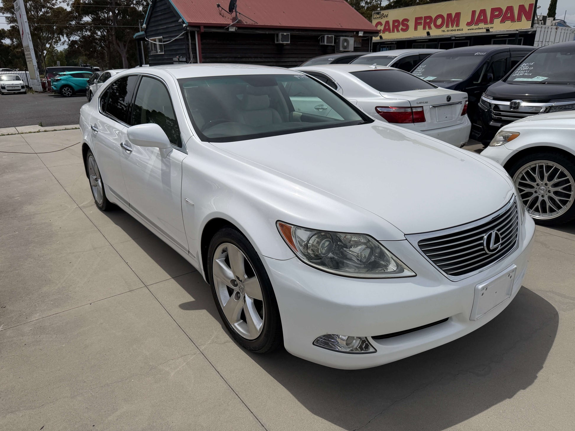 2007 Lexus LS460 V8 4.6L Version S I Package luxury sedan in white parked outside, showing sleek design and premium features.