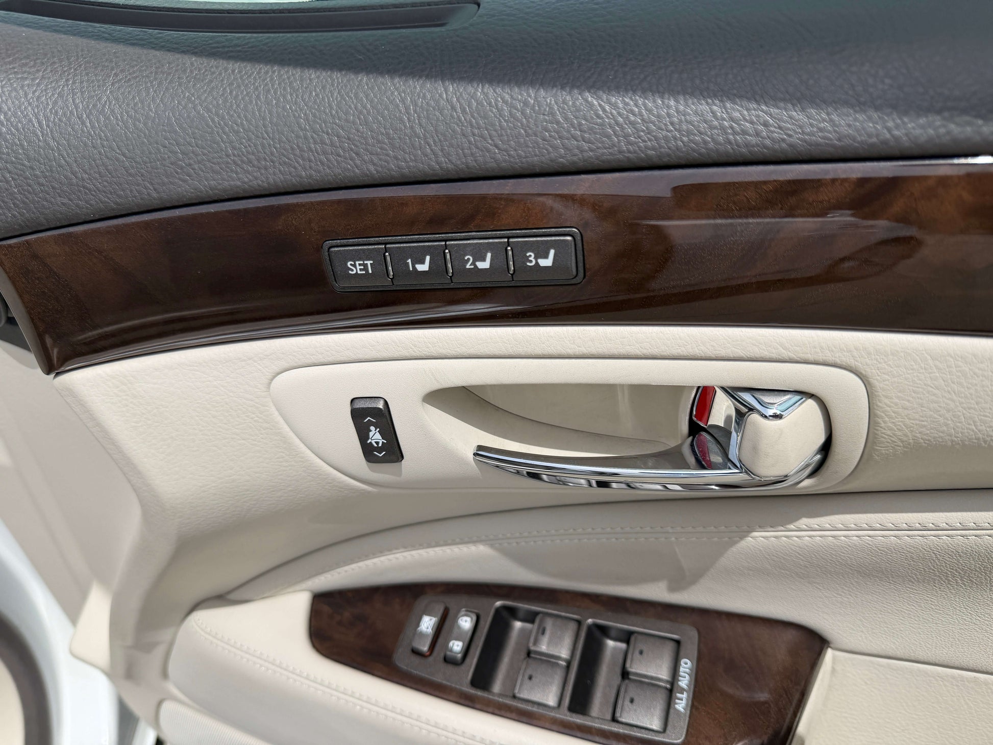 2007 Lexus LS460 V8 4.6L interior door panel with memory seat controls and handle.