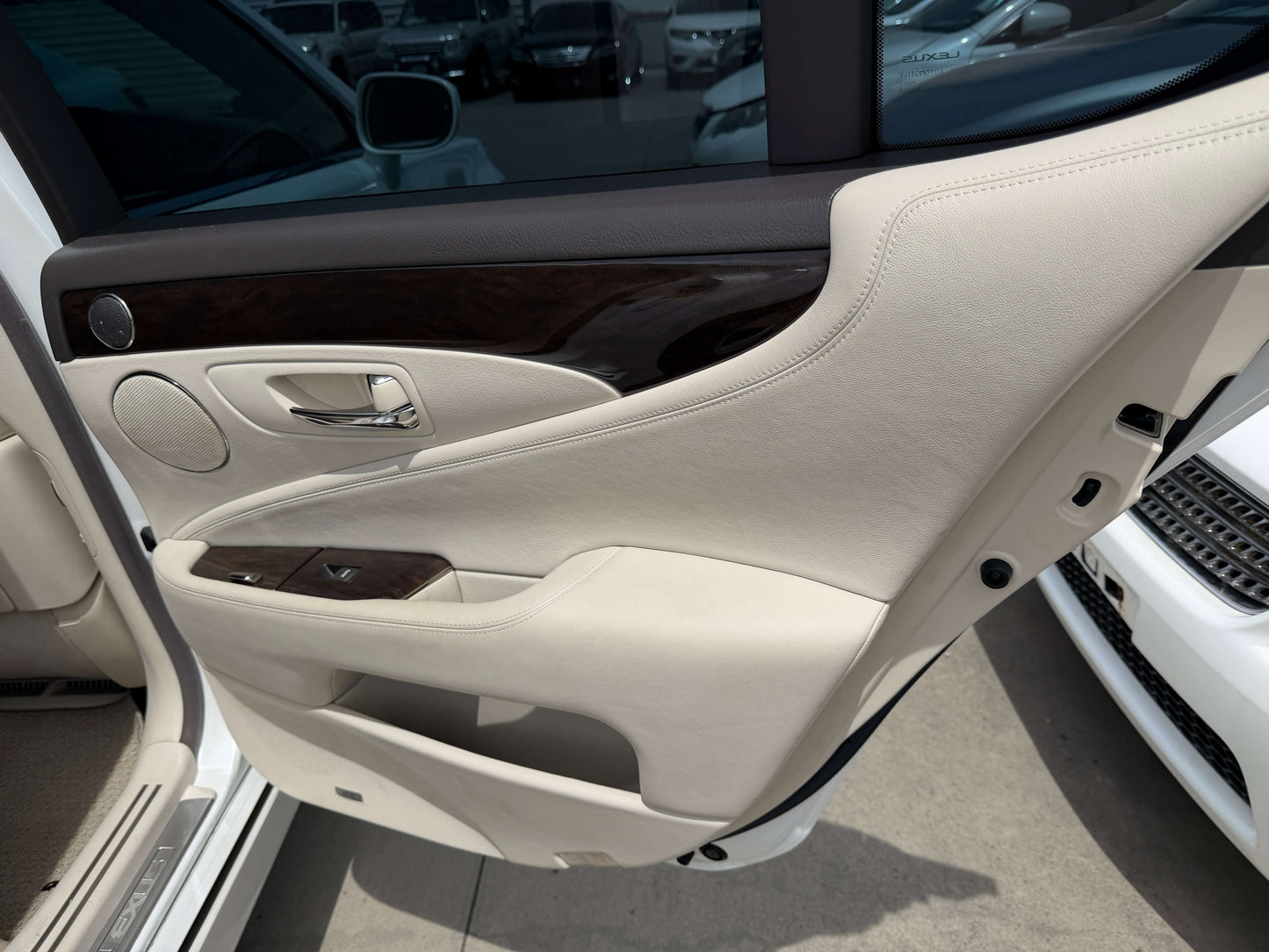 Interior view of the 2007 Lexus LS460 V8 4.6L showing luxurious beige leather door panel.