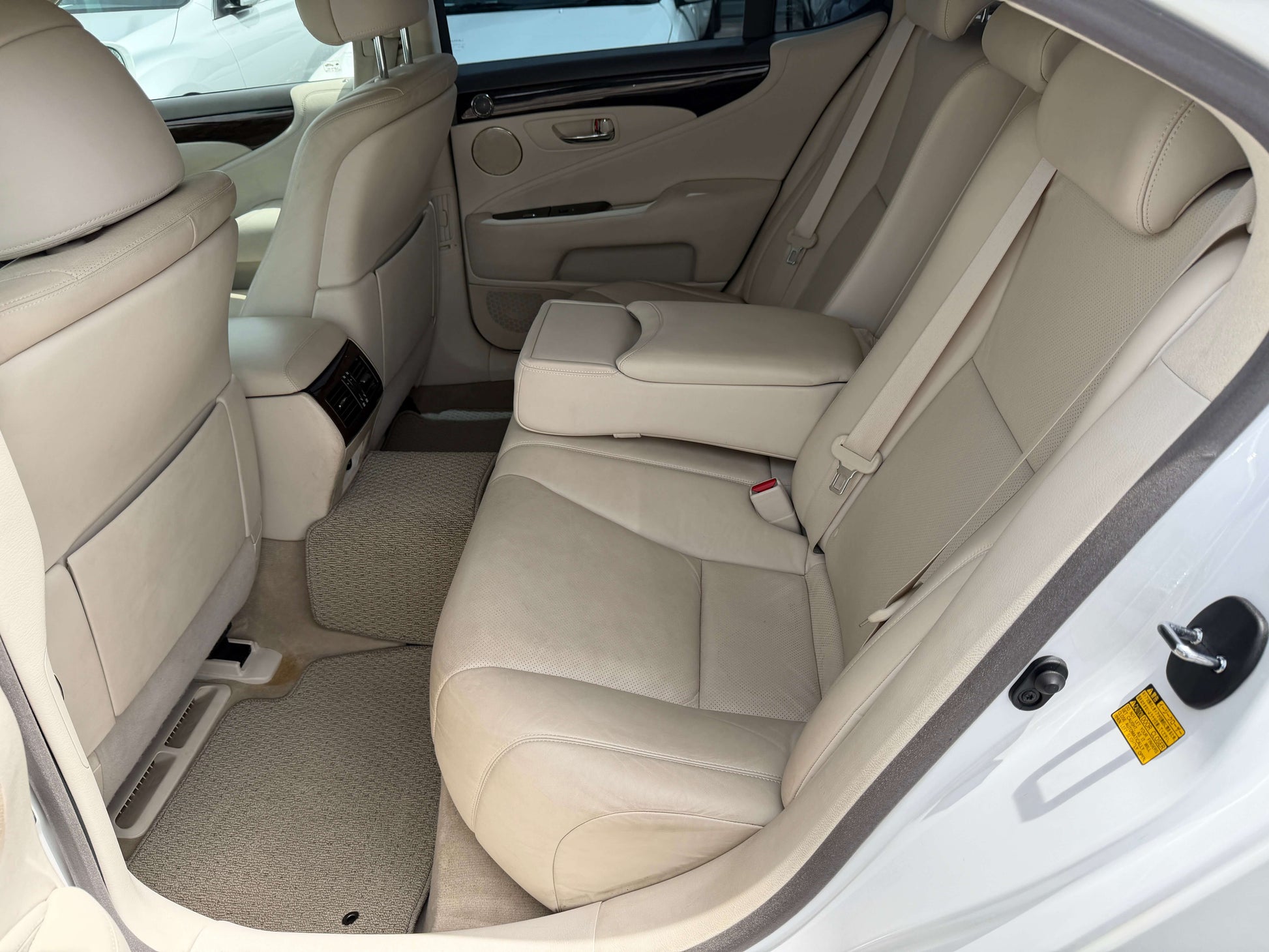Interior view of the rear seats in a 2007 Lexus LS460 V8 4.6L, featuring luxurious beige leather upholstery.