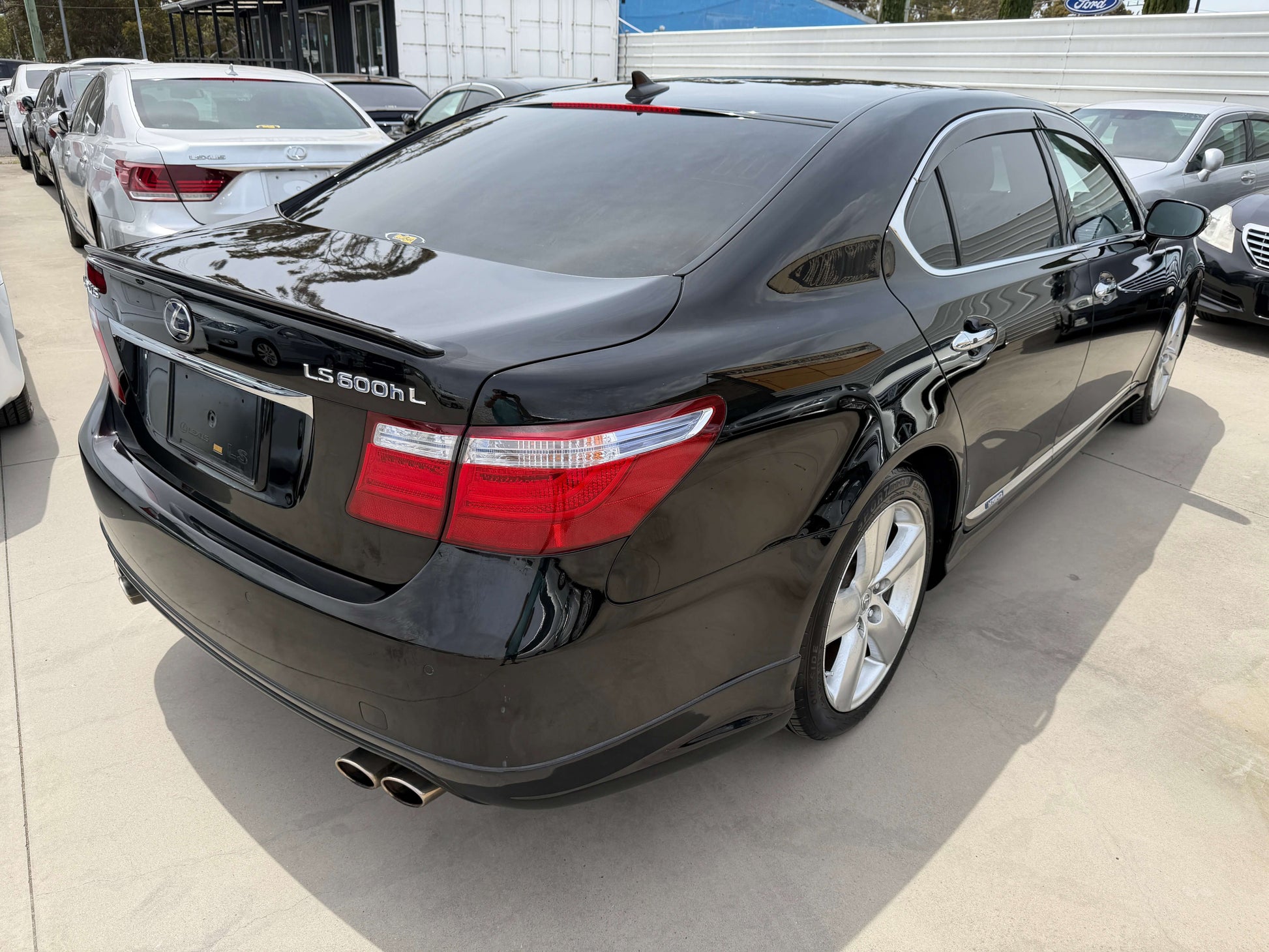 2007 Lexus LS600hL AWD V8 5.0L Hybrid luxury sedan rear view in black color with elegant design.