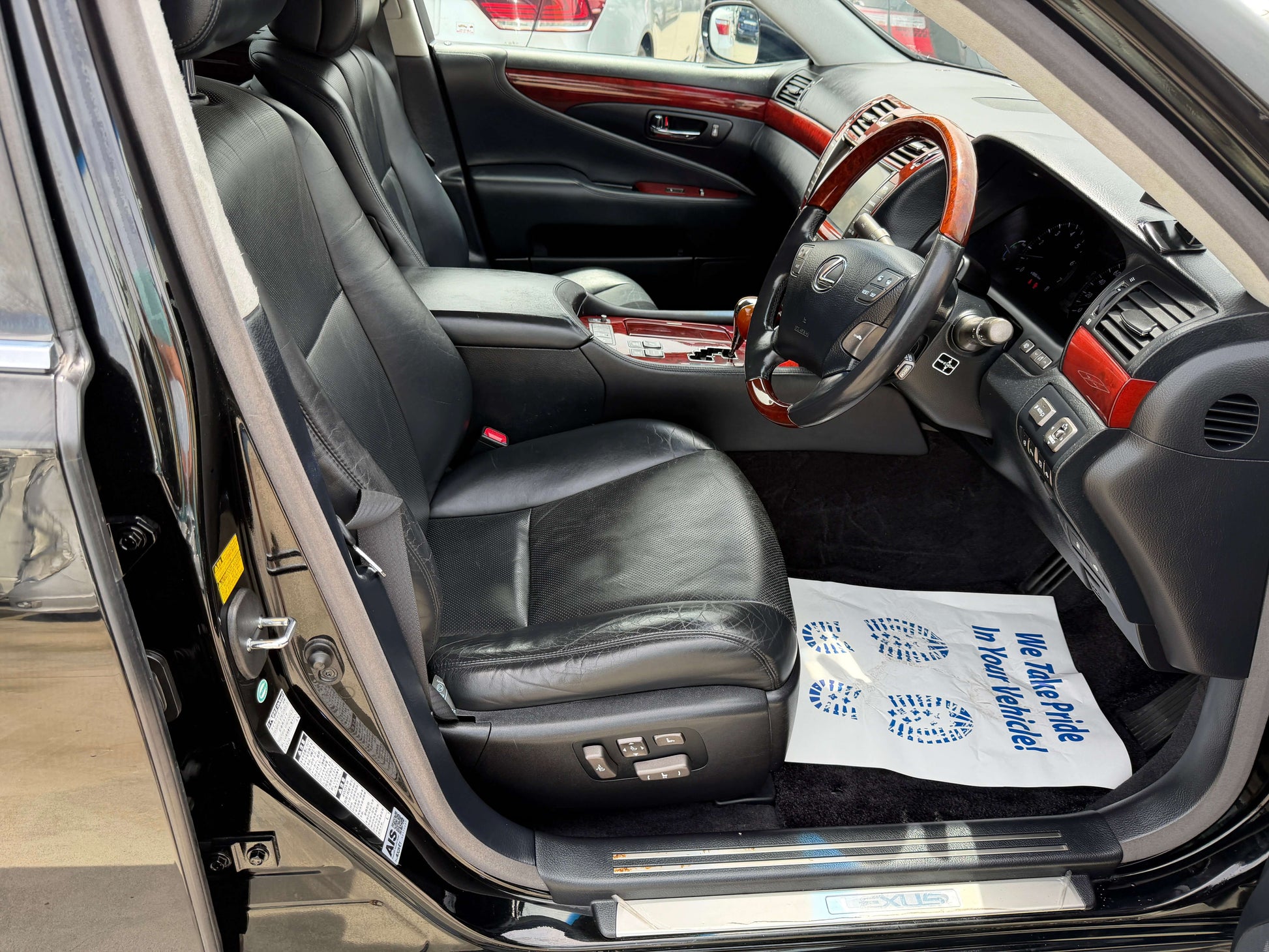 Interior view of the 2007 Lexus LS600hL AWD V8 5.0L Hybrid luxury sedan, showcasing leather seats and wooden accents.