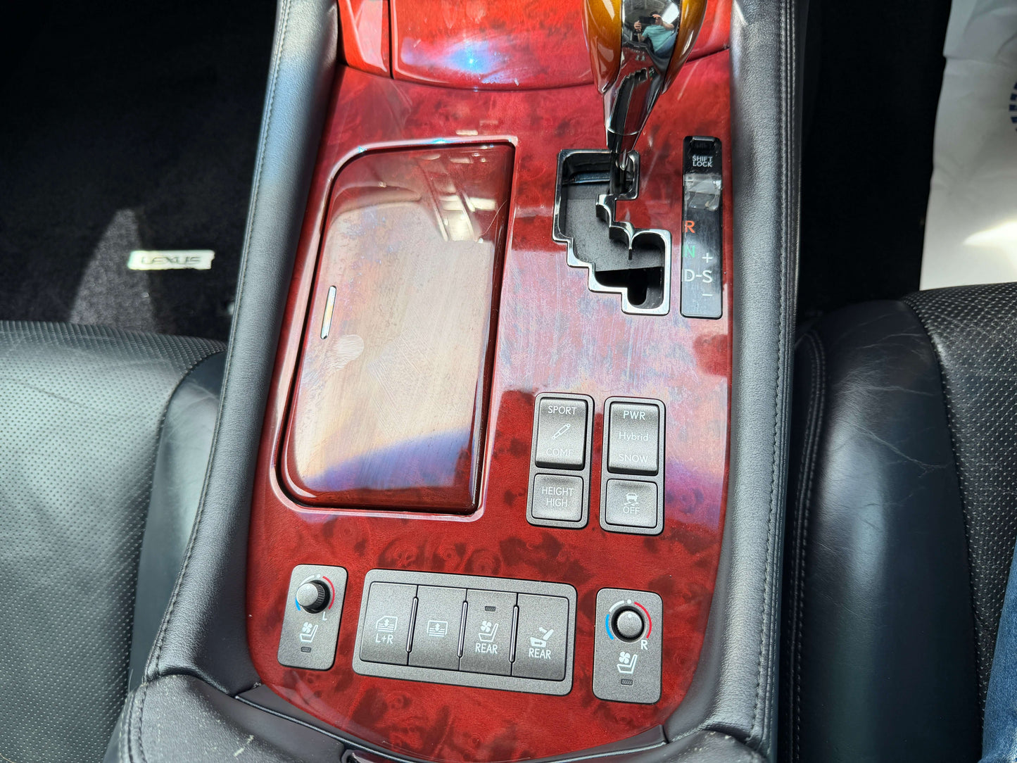 Interior console of a 2007 Lexus LS600hL AWD V8 5.0L Hybrid luxury sedan with controls and wood accents.